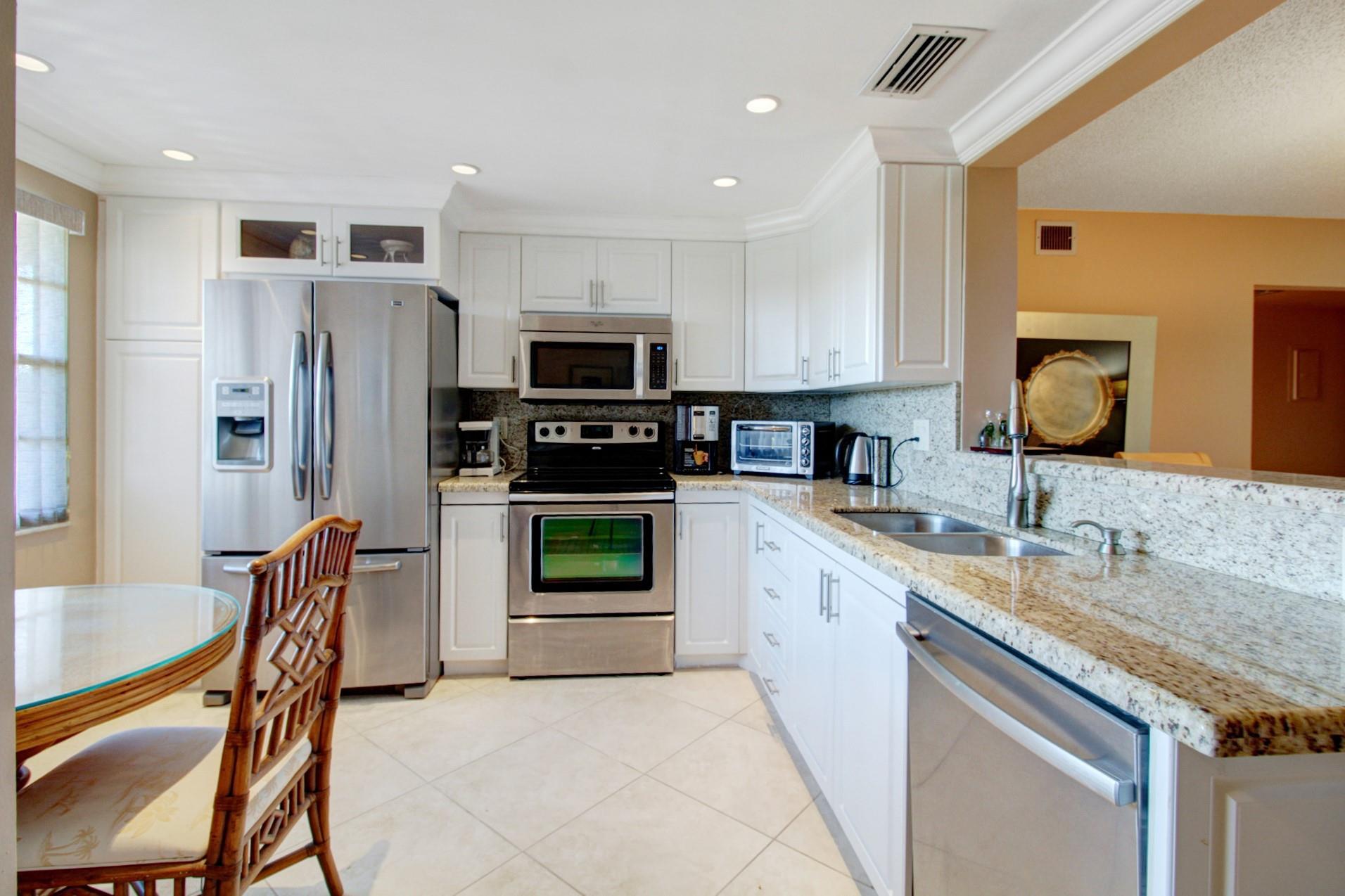 Beautiful 2 Bedroom, 2 Bathroom with beautiful views. Brand NEW A/C 6/2025! This condo features a beautiful eat in kitchen complete with granite countertops, and stainless steel appliances. Gorgeous neutral tile in the living areas, BEAUTIFULLY FURNISHED and move in ready. Incredible views! Wonderful Florida Room - with stunning tropical golf and lake views. The seller has maintained this unit beautifully and it is tastefully decorated. Wynmoor is a 55+ community with incredible amenities, you can relax and enjoy the views, enjoy the local satellite pool that is just steps away, or participate in all this community has to offer - activities galore! Perfect for seasonal or year round living, move in ready!