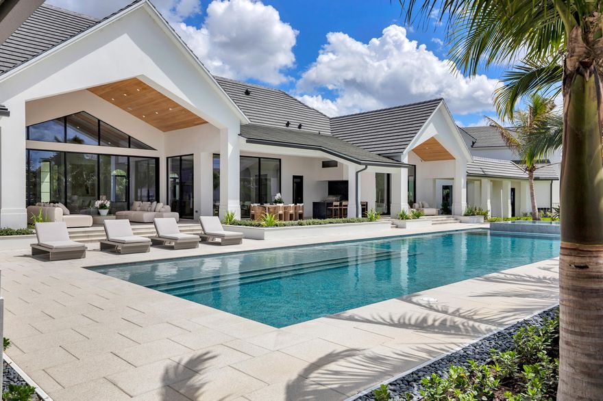 The most anticipated home in Aero Club has arrived. Designed by Diaz & Lang with interiors by HW Interiors, this custom 5 Bed 6.2 Bath estate sits on a lot and a half and has just been completed, ready for its first owner.  Aero Club is one of South Florida's most coveted addresses, an aviation community unlike any other with its own private runway. This property delivers on every level: 8,400+/- sq ft under air across the main residence, a 70'x60' (4,400+/- sq ft) primary epoxy hangar, and a third structure with an additional 2,000+/- sq ft of epoxy hangar space all attached to the main home via covered breezeway.  The kitchen features a custom fluted pill-shaped oak island accompanied by a Wolf six-burner cooktop with griddle, Wolf double oven and warming drawer, Sub-Zero panel-ready  refrigerator and freezer, and a Bosch panel-ready dishwasher, stone backsplash with an in-wall sliding niche for spice storage, pot filler, and concrete pendant lighting overhead. The island features pop-up outlets and touch-latch cabinetry for ample storage. The hidden pantry features a second dishwasher, Wolf microwave and warming drawer, GE panel-ready ice maker, sub zero fridge and freezer, laundry sink and additional cabinetry.   The great room fireplace is flanked by floor-to-ceiling white concave wood fluting, built-ins with fluted wood backing and floating shelves, aged brass sconce lighting, and a herringbone brick firebox framed in mitered-edge stone. Warm, architectural, and entirely custom.  The wine pantry features a Sub-Zero fridge, stone bookmatched back wall, floating white oak shelves, and fluted cabinetry with touch-latch doors making this a showcase for any wine collection.  The primary suite bathroom is one of many jaw-dropping spaces in the home. A solid concrete 72" soaking tub, floor-to-ceiling honed marble shower, sinks with brushed brass custom stone handles, mosaic flooring throughout, a custom stone-trimmed mirror, and a full thermostatic, waterfall, and handheld shower system. Every detail was chosen with intention.  Each additional bathroom carries its own character — Calacatta gold marble and a designer tub in Bath 1, penny round matte white flooring and a two-inch stone countertop in Bath 2, Moroccan mosaic tile and a custom integrated stone vessel sink in the powder bath, and a green absinthe trapezoid tile with vintage brass fixtures in the cabana bath. No two bathrooms feel the same.  The dedicated fitness room pairs with a full steam suite featuring a Thermasol touch control system with Bluetooth capability, a Brizo Odin thermostatic shower system, and floor-to-ceiling stone across walls, floors, and ceiling. The playroom/office features a 141-inch built-in desk, cork board, and custom rift-cut white oak cabinetry. Upstairs, a second bar with Sub-Zero fridge, GE nugget ice maker, and Wolf microwave keeps the second level stacked for those perfect movie nights or hangouts.  Outside, the summer kitchen is built around a Piasentina sapiens stone waterfall countertop, Wolf outdoor grill, two Wolf built-in burners, and a Sub-Zero panel-ready refrigerator — all under a Tradewinds outdoor hood. The heated/chilled saltwater pool & spa are surrounded by covered outdoor living areas which make this backyard perfect for year round swimming and entertainment. The backyard faces due west which provides picturesque sunsets.  Homes finished to this level do not come around often. This estate is ready for occupancy!  Aero Club is located just minutes away from the Winter Equestrian Festival. Wellington Aero Club is a private aeronautical community located in Wellington, Florida. It features 240 custom-built homes on one-acre lots, many with private hangars, and a lighted and paved 4,000 foot runway. There is also AV Gas available directly at the airport.