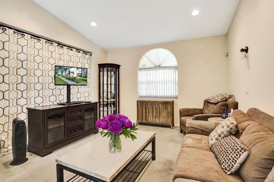 This charming 3-bed / 2-bath condo, offers a relaxing lifestyle in a vibrant, gated, all-ages community! This 2nd floor unit offers plenty of privacy and added space, including luxurious vaulted ceilings, convenient attic access for additional storage, professionally installed closets, shelving, custom recessed lighting, and additional switches and outlets spaced throughout. The fully-enclosed Florida room features impact windows and sliding doors, with custom shelving and ample space for use as a guest bedroom or home office. Unit is very close to assigned parking, trash/recycling bins, and mailbox, and a secondary pool location! Community clubhouse features a magnificent swimming facility, fitness center, restaurant/cafe, tennis/pickleball courts, and much more!  Schedule tour today!