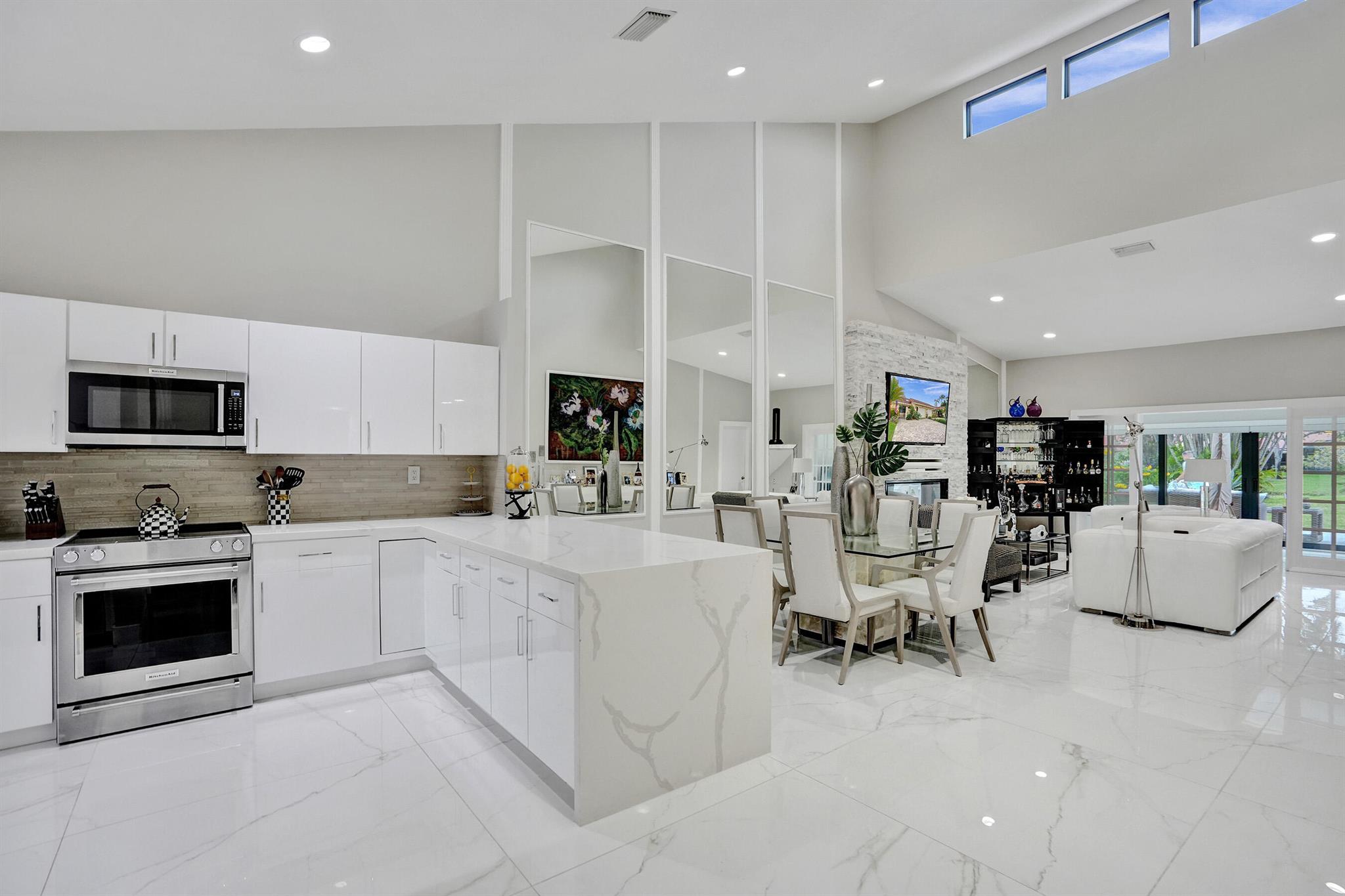 Stunning 2 bedroom 2 Bathroom villa nestled in the heart of Deerfield Beach. Completely renovated with modern and sleek finishes. This property has over the top features meticulously maintained. Stainless Steel appliances, 4X4 Porcelain Tile throughout, soaring high ceilings, spacious kitchen with ample counter space and beautiful cabinetry, wet bar, Florida room leading to a private patio finished with gorgeous travertine tile, an outdoor shower & fans, pizza oven, 1 car garage with an epoxy finished floor. The Master suite has 2 huge walk in closets, stunning master bath with oversized mirrors and dual vanity's. Brand New Hurricane impact windows and sliders. Close to beaches shopping and great restaurants. Pool located conveniently close to unit! Amazing opportunity to own this Gem!