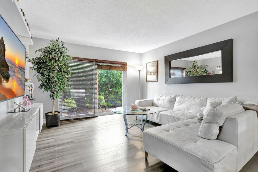 Move-in ready and thoughtfully updated, this charming 2-bed, 2-bath first-floor condo is located in a well-maintained boutique building in a prime location with the beach just minutes away. The home features impact windows and doors, newer flooring throughout, and an updated kitchen with granite countertops and stainless steel appliances. Both bedrooms offer private en-suite baths, with the primary suite featuring a walk-in closet, while the second bedroom's bathroom includes space for a washer and dryer. Additional highlights include a newly upgraded electrical panel, a screened front porch, private back patio, dedicated storage unit, and covered parking. Residents enjoy access to a community pool and clubhouse, all conveniently close to shopping and dining.