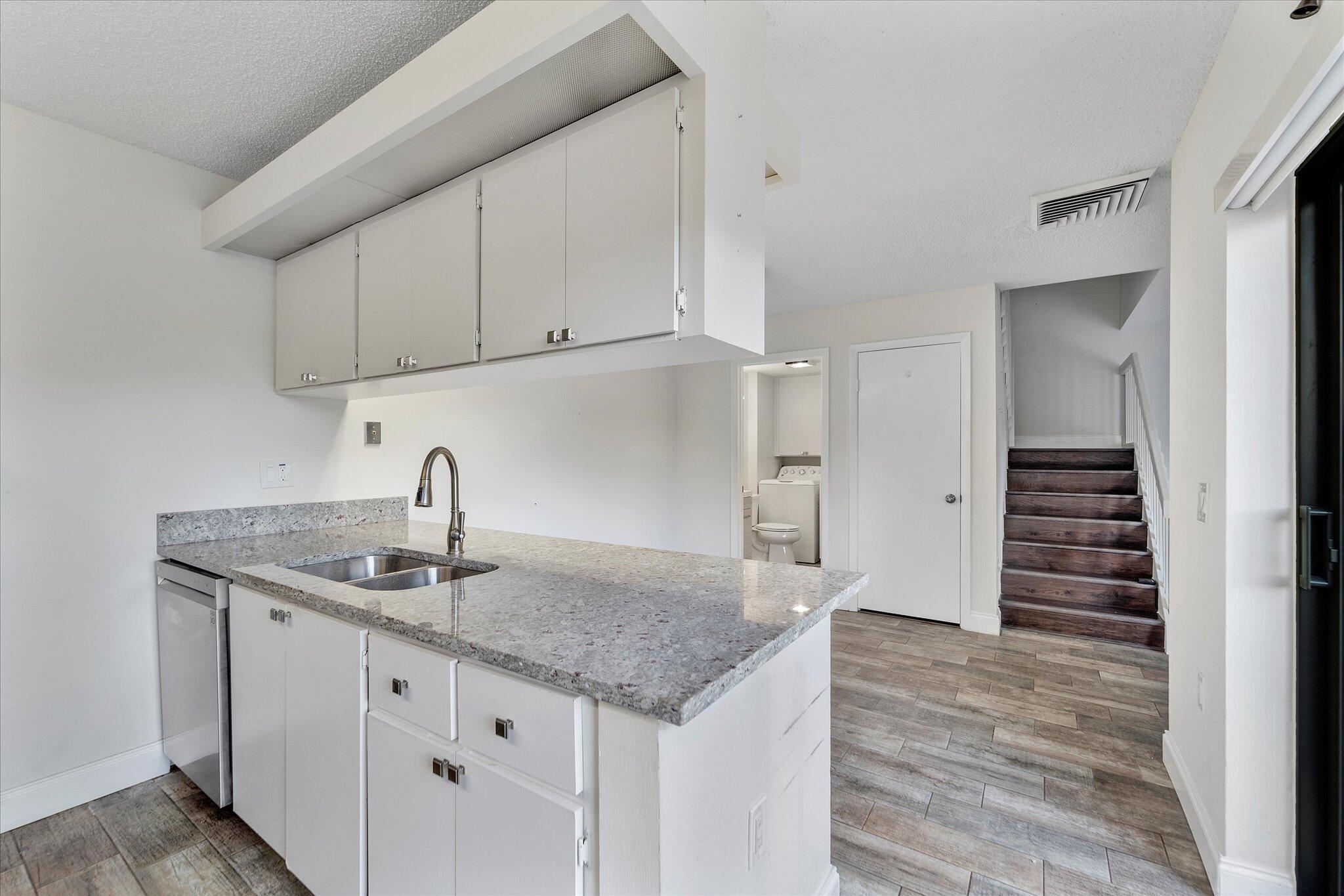 Beautifully updated and move-in ready 2-bedroom, 2.5-bath townhome located in the desirable Waterside Luxury Townhomes community. This bright and airy home features a modern kitchen with new stainless steel appliances and granite countertops, and new laminate floors throughout for a sleek, contemporary look.Both bedrooms offer private en-suite bathrooms, and there's an additional half bath on the first floor along with a washer and dryer. The spacious living area opens to a private courtyard, perfect for relaxing or entertaining.Residents enjoy access to excellent amenities including a fitness center, pool, and tennis courts. Conveniently located less than 10 minutes from Palm Beach International Airport, Brightline Station, Downtown West Palm Beach, and The Factory Outlet Mall, t
