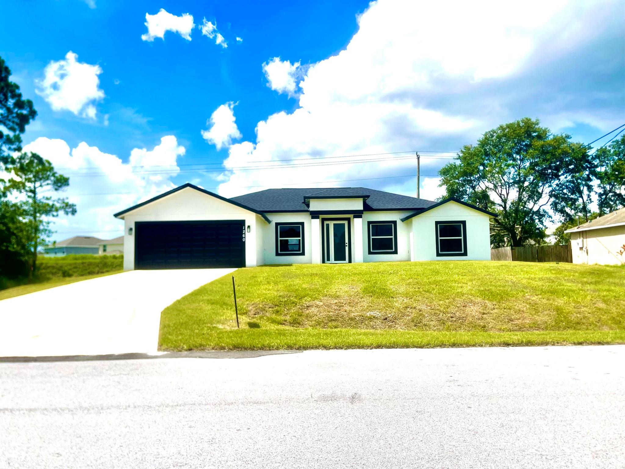 Move-In Ready New Construction - NO HOA - Seller Offering $4,000 Toward Closing Costs with Full Price Offer! This 4-bedroom, 3-bathroom home with a spacious den is located on a quiet street with no rear neighbors. Featuring hurricane-impact windows, wood-look tile throughout, high ceilings with coffered details, granite countertops, and stainless steel appliances, this home blends quality and style. The master suite offers dual sinks, a walk-in shower, and a jacuzzi tub. A cabana bath and sliding glass doors lead to a large covered porch--perfect for enjoying peaceful views. The flexible den space is a valuable bonus, ideal for an office, guest room, or playroom.