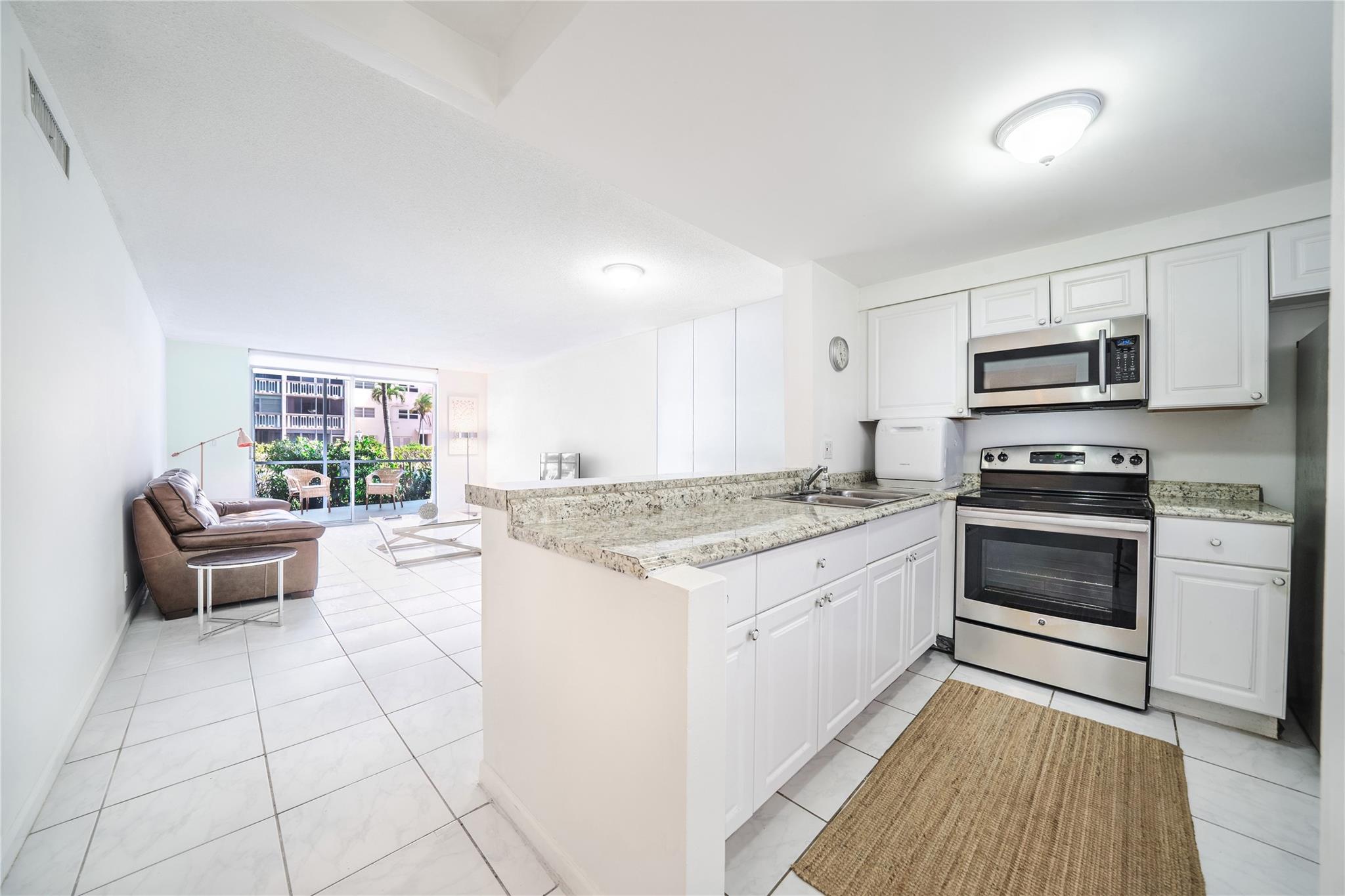 Step into comfort and convenience in this beautifully updated ground-floor condo in the heart of Hallandale Beach. This spacious 1-bedroom, 1.5-bath unit offers 867 sq ft of bright, open living space with a modern layout, fresh paint, and a brand-new A/C system. Including the private patio, the total area is approx. 1,033 sq ft. Enjoy a partially furnished interior (just bring your bedroom set!) and direct access to your green backyard and the community pool from your patio door. Just 5 minutes from the beach and walking distance to shops, restaurants, and entertainment. The Meadowbrook community offers a clubhouse with Wi-Fi, gym, library, game area, heated pool, and laundry facilities. Cable, water, sewer, and trash included in rent. Move-in ready—schedule your showing today!