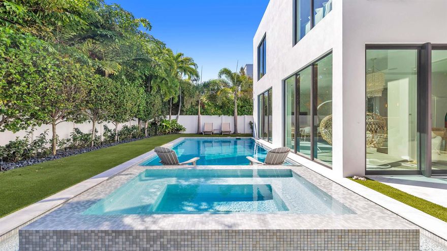 Built in 2021, this incredible contemporary residence is located in Boca Villas just one block from the famed Mizner Park and one mile to the beach. Features include volume ceilings; state-of-the-art AV system; designer touches throughout; and resort-like grounds to create an oasis for residents and guests alike. Boasting almost 6,500 total square feet, the five bedroom home offers spacious living areas; fabulous kitchen with snack bar seating; custom wine storage; and floor-to-ceiling windows and sliders that provide natural light and stunning views of the tranquil pool and grounds. The primary suite provides a private retreat with sitting room with morning bar; dual closets; spacious bathroom; and dedicated washer and dryer.