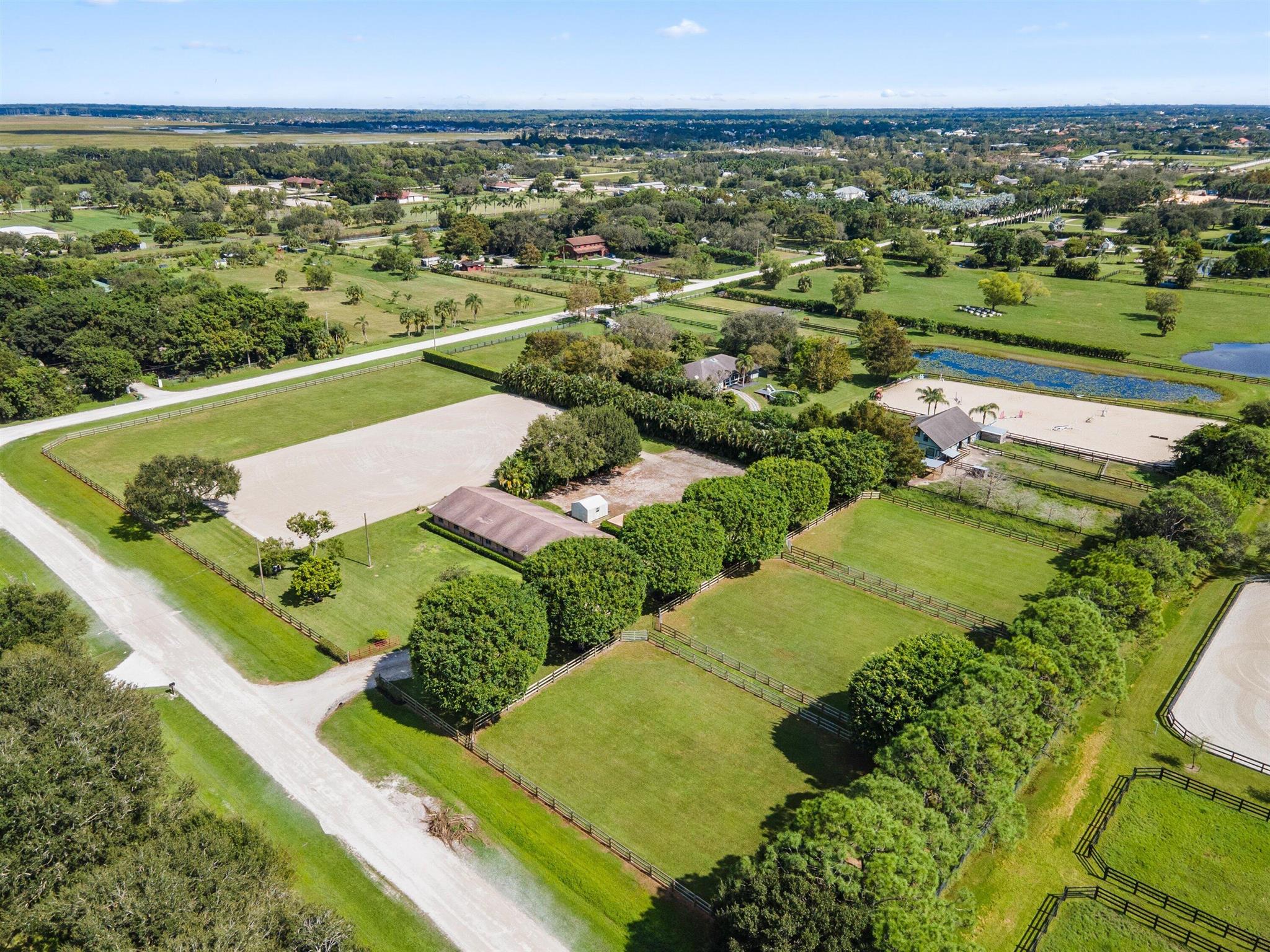 This is your opportunity to lease a much admired equestrian property in Rustic Ranches. This 5 acre farm with 10 stalls, oversized paddocks, large sand arena, 2 RV hook-ups tack & storage rooms, ample parking & trailer storage and city water has it all. The entire perimeter is fenced. The majestic ficus tress frame the entrance to the property and paddocks. Only minutes from the Wellington Nature Preserve with miles of trails for your riding pleasure. Truly a Must See property!