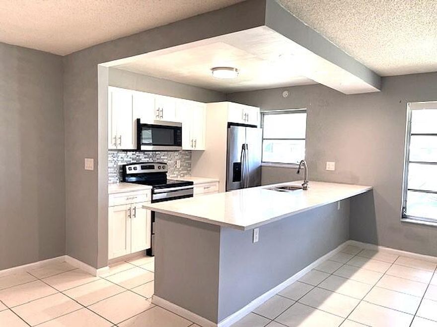 Beautifully Updated 1BR/1.5BA Villa in Vibrant 55+ Community Enjoy easy Florida living in this partially updated 1-bedroom, 1.5-bath villa, ideally located in a highly active 55+ community. This light-filled home features an open-concept kitchen with white shaker, soft-close cabinetry, sleek quartz countertops, and a neutral glass tile backsplash. Newer stainless steel appliances and modern high-hat lighting complete the space. Additional highlights include: Lennox A/C (2018), Water heater (2022), Neutral 18" tile flooring throughout, Updated guest bathroom Dual stainless steel sink with gooseneck faucet, enclose Florida room with new windows Private backyard patio. Residents enjoy resort-style amenities, including a large heated pool, clubhouse, shuffleboard, and a full calendar  of social activities, Conveniently located just minutes from the beach and vibrant downtown Delray Beach, offering boutique shopping, open-air cafés, fine dining, entertainment, and more. Easy access to I-95 and the Turnpike. Each building (4 villas) includes a shared coin-operated washer and dryer.