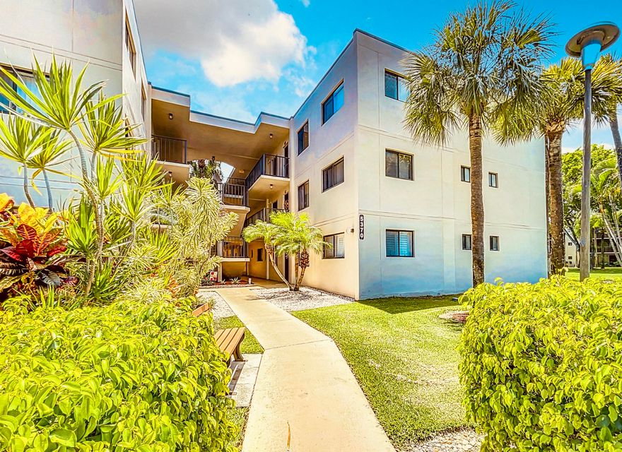 Spacious 2-bedroom, 2-bath corner unit located on the second floor in an elevator building. One of the larger models in the community, this home offers extra windows for added natural light, a large eat-in kitchen with a screened balcony, a dining area/den with decorative mirrored walls, a generous living room, and a spacious primary suite with a walk-in closet and bidet in the primary bathroom. Tile flooring runs throughout the living areas and kitchen, while the bedrooms feature carpeting for added comfort. Additional highlights include two parking spaces, a new washer and dryer, new water heater, and new screens throughout. Located in a 24-hour gated community just steps from the clubhouse, main pool, and tennis courts. Conveniently situated near hospitals, shopping, dining, golf, major