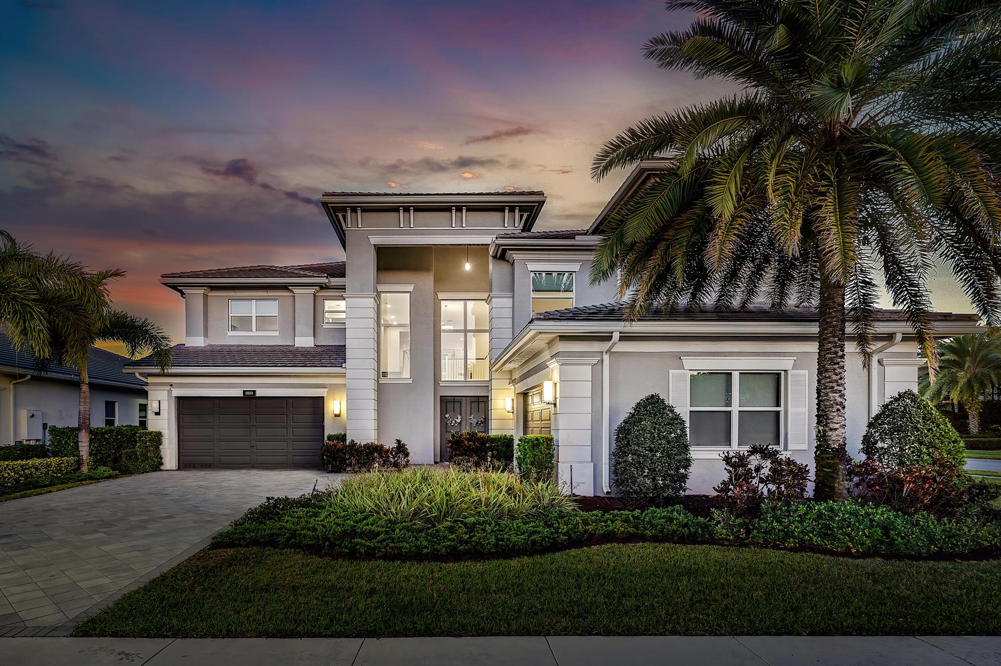 Welcome to 19894 Meadowside Lane, an exceptional residence located on an oversized corner lot in the prestigious gated community of Berkeley in Boca Raton. This luxurious Riverside model built by GL Homes in 2020 offers 5,752 sq ft of elegant living space, including 5 bedrooms, a media room, a loft, 5.1 baths, and a 4-car garage (2 separate 2-car garages). With its impeccable craftsmanship and thoughtful design, this home is a masterpiece of contemporary living. The grand entryway flows seamlessly into spacious, light-filled living areas. The gourmet kitchen is a chef's dream, featuring custom cabinetry, quartz countertops, a center island with bar seating, top-of-the-line appliances (gas cooktop), and a breakfast nook, all open to the Great Room, perfect for entertaining.