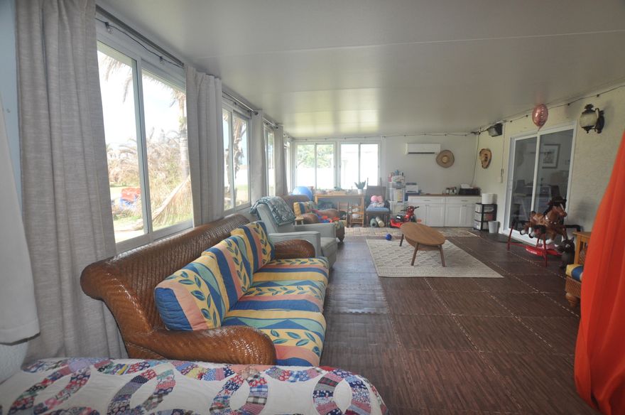 You will fall in love with this home that has a special room 16'x 30' (approx) on the back...big enough for play room with pool table or pingpong table, or a huge quilting room, or ????, has Split Bedrooms, a kitchen with office or organizational area at one end with doors going out to covered patio with outdoor shower. Extra large back yard. side driveway area. Screened front porch so you can open up your whole house and let the nice Florida breeze flow through.  East PSL near Greenriver Parkway There are two Refrigerators ..the newer one  does not stay!  The total sq. ft of living area: 1183 plus 480 rm on back=1663. then add on the garage = approx 1863 sq feet. The room on the back has some special papers with it. A cute home on an oversize lot!