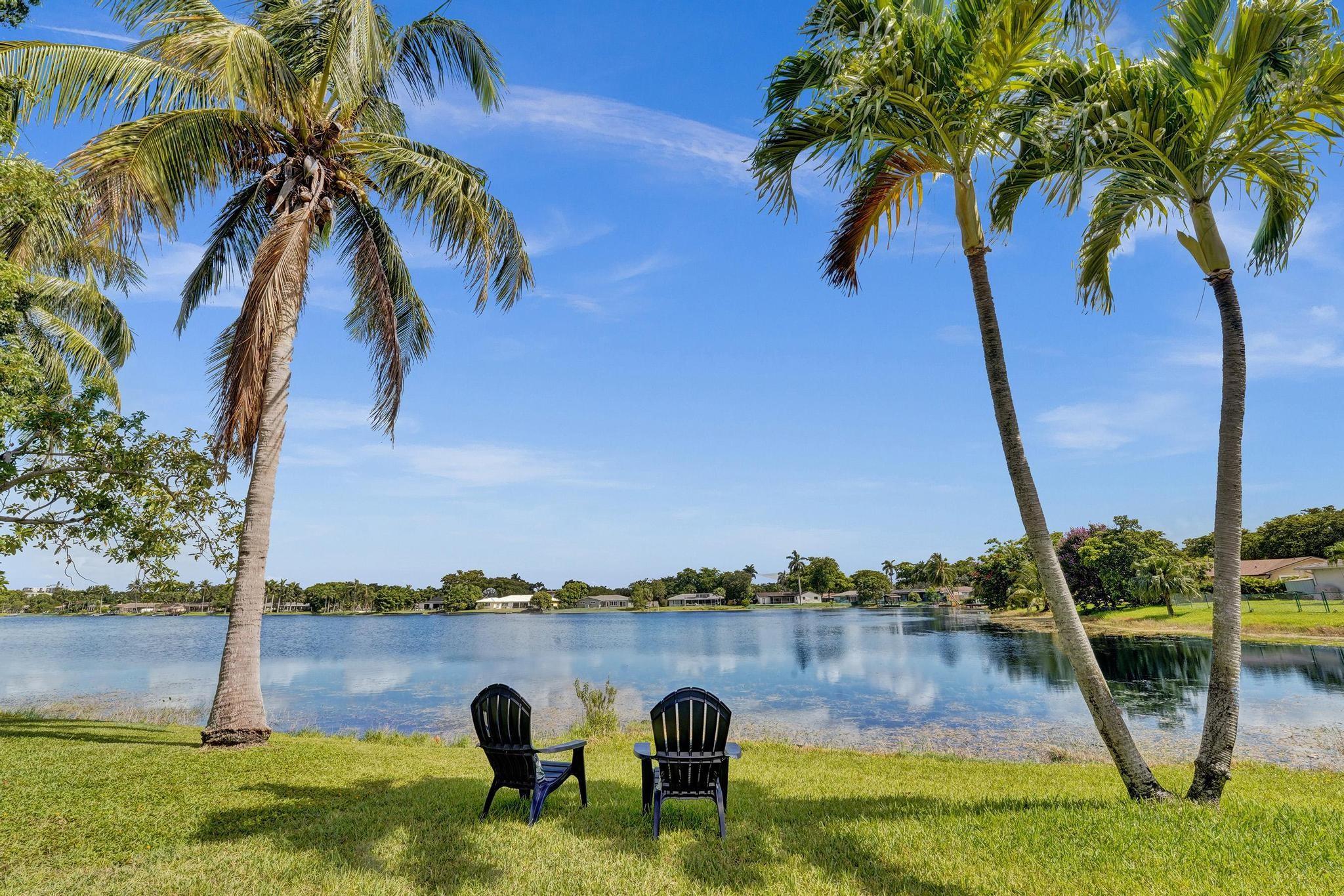 "Paradise in Plantation" in this WATERFRONT POOL HOME situated on an oversized 12,000 sqft lot! This single story has 3 spacious bedrooms on one side PLUS AN OFFICE off of the family room. Nestled in the desirable Royal Palm Estates community, known for it's cascading tree lined streets, peaceful lakes, large lots & NO HOA! NEW impact doors & windows, A/C (2021) Nest Thermostat, PVC plumbing, flat roof (2021) & certified tile roof. Interior is boasting with brand new luxury vinyl flooring, remodeled kitchen w/ white cabinetry, sleek counter tops & kitchen island. NEW modern spa-like bathroom & stylish fixtures. Freshly painted in/out, smooth ceilings & recessed lighting. Enjoy backyard BBQs soaking up the sun in the pool, watching sunsets from your patio, & boating/fishing on the lake.