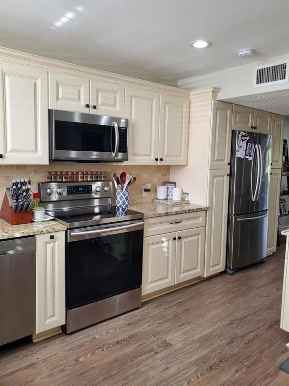 Beautiful completely updated and spacious 2 bedroom Townhouse in the desirable Fountains Country Club. Large updated, kitchen with center Island and built in wine cooler w/ lots of cabinets, both bathroom completely up-dated. washer and dryer in unit, French doors lead to the enclosed Florida room which adds additional sq footage to this unit. Beautiful water view from outdoor patio to enjoy your morning coffee or entertain your guest. Safe secure community with manned guard gate and 24hr security drive patrol.