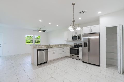 Photo of 696 NE Waters Edge Lane, Port Saint Lucie, FL 34983 (MLS # B26021087)