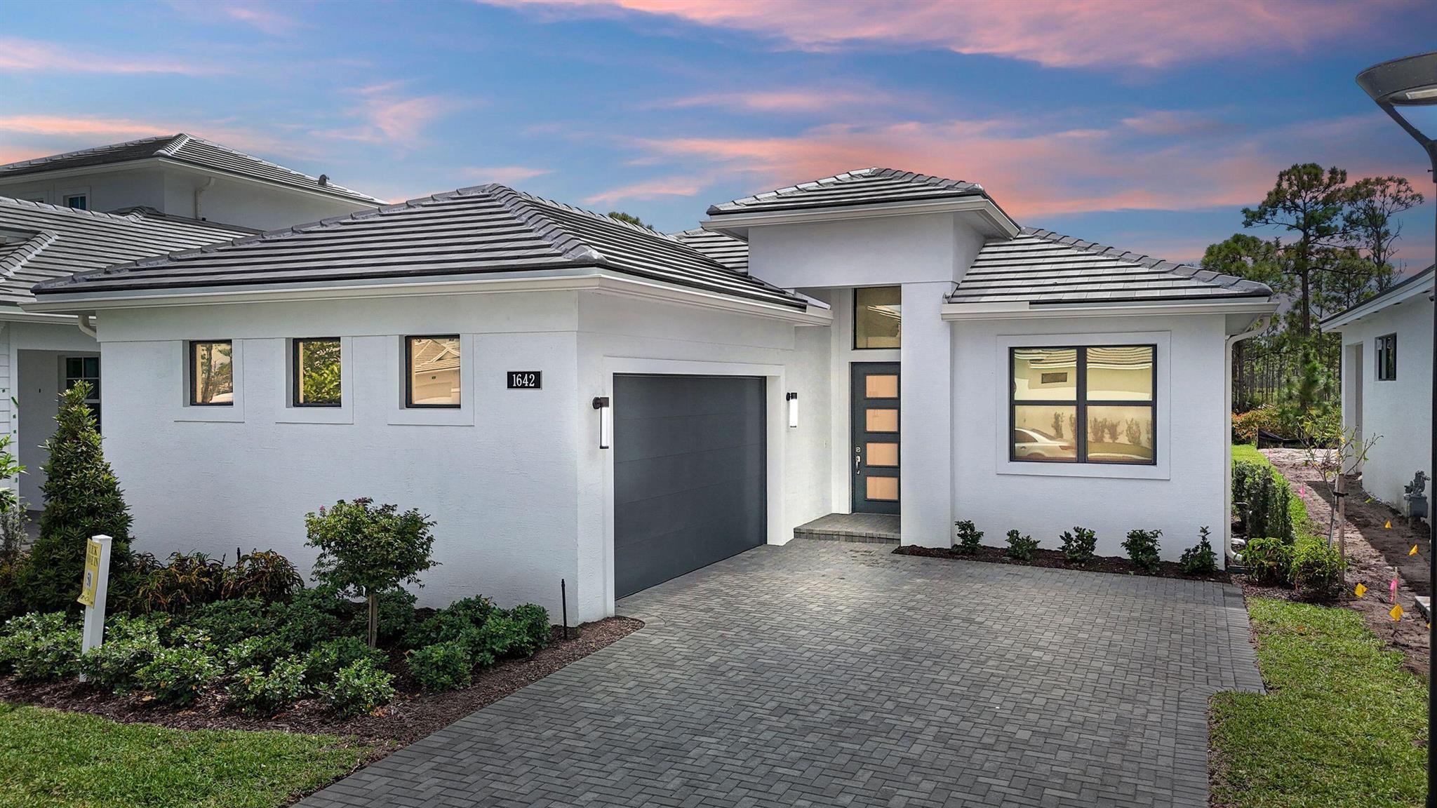 **New Construction** Move-in-ready available. Backed by the scenic Atlantic Ridge State Park, this move-in ready Lila home in Cove Royale offers preserve views and added privacy. The Lila floorplan features 3 bedrooms, 3 bathrooms, a flex room, and a 2 car garage. The kitchen is design with high end finishes, including a 48'' refrigerator, 38'' gas range, quartz waterfall island, matte pearl backsplash, and second tier cabinets with display lighting for showing off all that beautiful kitchenware. A 10' x 16'' sliding glass door brings in all the natural light and connects the great rooms to the outdoors, making the views of the Atlantic Ridge State Park picturesque.