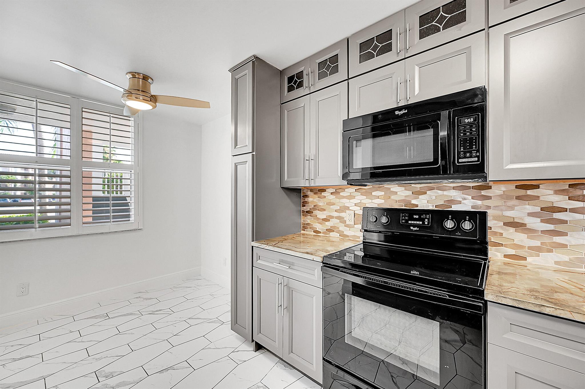 Beautifully updated 3 bedroom, 2 bath first-floor corner condo in the prestigious ''The Island'' at Sunrise Lakes, 55+ resort-style community. This home exudes pride of ownership and meticulous attention to detail, offering a perfect blend of elegance, comfort, and functionality. Offering soaring ceilings, an abundance of natural light, and a thoughtfully designed open layout. The living space is adorned with high-end finishes throughout, including impact windows, custom built-in closets, and modern tile flooring. The kitchen boasts sleek cabinetry and ample counter space. Enjoy the convenience of a full-size washer and dryer, a new A/C unit, and breathtaking lake views. Amenities include: 5 pools, gym, billiards, library, theater, tennis and golf course. DON'T MISS OUT.