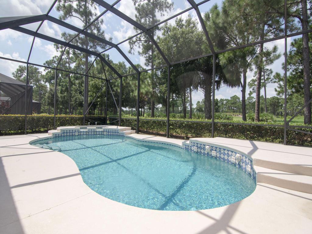 You will be delighted at the view as you walk through the etched glass double doors to see the enticing blue water of the pool calling you on a hot summer day with a back drop of the 14th hole of the Wanamaker golf course at PGA Village. With 2382 under air you will enjoy a spacious home featuring two bedrooms and a den large enough to accommodate guests. There are three and a half baths, one of which is a cabana bath . Kitchen features stainless steel appliances, a large pantry, under cabinet lighting and granite counter tops. Multiple options for dining include a high top breakfast bar, the breakfast nook with a seamless glass view of the golf course, a formal dining area, plus the huge over hang of the screen lania for outdoor cooking and dining. The pool can be accessed thru
