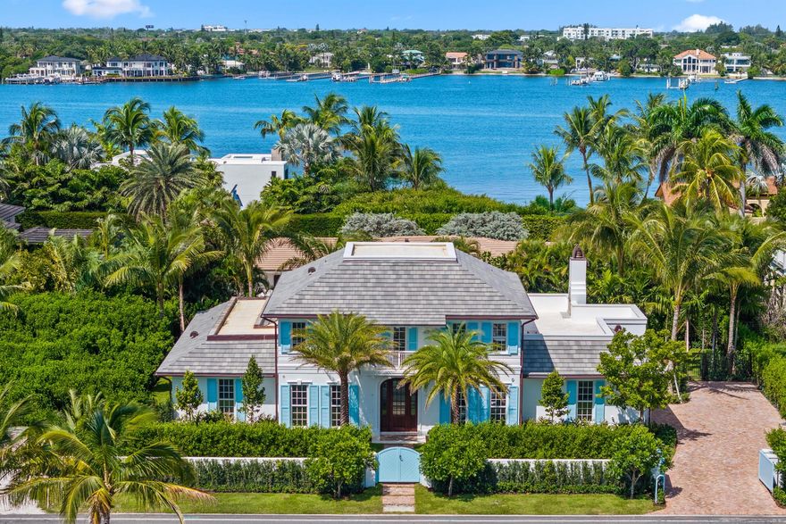 JUST COMPLETED - BRAND NEW CONSTRUCTION 2025! Set on the private shores of Palm Beach's Ibis Isle, this elegant designer residence defines seamless indoor-outdoor living. The gracious 12,314 SF property is wrapped in lush landscaping & offers 5 bedrooms & 5.1 bathrooms, a first-floor primary suite with vaulted ceilings & a Calacatta marble spa-inspired bath. Oak flooring runs through the main living areas & is complemented by high ceilings & top-tier finishes. The open kitchen showcases a custom Officine Gullo range, Miele appliances, and marble countertops. Upstairs, 3 ensuite bedrooms & a loft that opens to a spacious rooftop terrace with a wood-burning fireplace. Outdoor spaces feature a heated pool, summer kitchen, two-car garage & elevator ready. Exclusive, secure, & just steps from