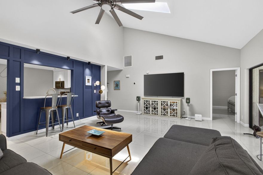 Welcome home to this exceptional residence in the highly sought after Park Place of Wellington, where a 2020 roof, impact windows, and beautiful updates throughout create the perfect blend of comfort, style, and peace of mind. Just minutes from Wellington International and the National Polo Center, and set in the heart of Wellington's renowned equestrian community, this beautifully remodeled residence also offers walking distance to the Wellington Amphitheater, where you can enjoy concerts, food truck events, art festivals, thrift sales, and more. Inside, you are welcomed by a stunning foyer with an artistic light fixture and elegant marble floors. Fresh light gray paint, 24 inch marble tile flooring, and vaulted ceilings create a bright, open, and sophisticated feel throughout the home.   The updated kitchen is designed for both everyday living and entertaining, featuring soft gray quartz countertops, white shaker cabinetry, brand new Samsung appliances, upgraded recessed lighting with 8 mini LEDs, a generous pantry, and a charming breakfast nook with custom recessed lighting in the overhead soffit.  The family room is especially impressive with soaring 18 foot ceilings and multiple sliding glass doors that open to an oversized, fully enclosed patio, creating the perfect year round space for relaxing or entertaining. Beyond the patio, the backyard offers a peaceful open setting with plenty of room to enjoy the outdoors.  The primary suite is a true retreat, complete with 16 foot ceilings, direct patio access, a large walk in closet, and a fully remodeled bathroom with dual sinks, custom designer mirrors, and a marble shower with pebble tile detailing. Upstairs, the loft functions beautifully as a second primary style suite with its own private bathroom, wood plank flooring, and vaulted ceilings. Additional bedrooms are spacious and offer ample closet space.  Thoughtful upgrades continue throughout, including a tastefully updated half bath, Nest thermostat, brand new washer and dryer, and a garage that feels like an extension of the home with an extra refrigerator, utility sink, a nook for a full size Craftsman workbench, high speed garage door opener, and pull down stairs to a large attic space.  Located in one of Wellington's most desirable communities, Park Place offers outstanding convenience and value. The HOA power washes driveways every 6 months, covers roof insurance for damage, and the community is being freshly painted right now. All of this, close to A rated schools, shopping, dining, I 95, the Turnpike, and the beach.