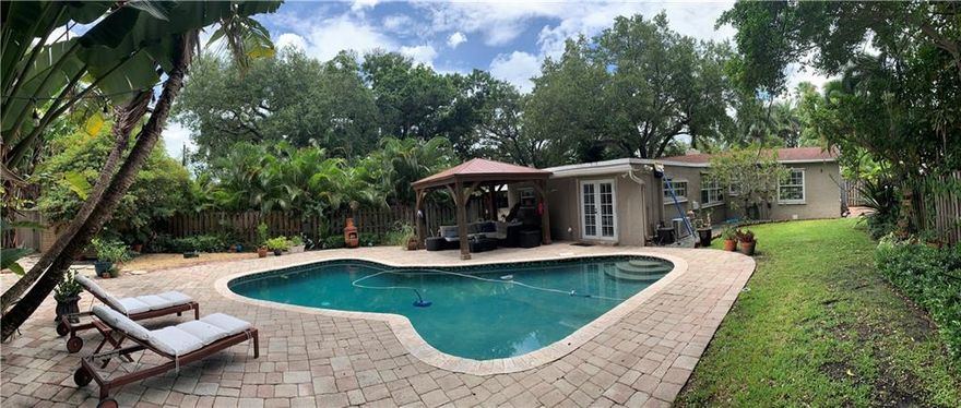 This beautifully updated home is just waiting for you! Featuring 3 beds, 2 baths and a huge storage room "man cave", this lovely property is well maintained with numerous personal touches throughout. An open living-dining area features a fireplace and built in office area. Kitchen has stainless steel appliances and built in wine rack. Master suite French doors lead out to pool area and the room has new "wood" tile floors, cedar walk-in closet and a modern en-suite bathroom. Two light and airy guest bedrooms have dual aspect windows. Property also has white plantation shutters and a tankless water heater. The fenced spacious back yard w/mature trees and plants features a salt water swimming pool w/large gazebo for entertaining and 2 storage sheds.This is definitely not one to be missed!