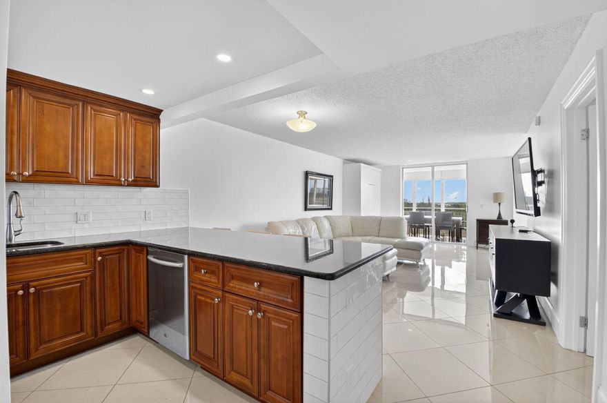 Pristine and fully updated, this penthouse-level 1-bedroom plus den, 2-bathroom condo is located in the highly sought-after Boca Teeca community, offering resort-style living with a heated pool and beautifully maintained grounds. This top-floor unit includes numerous upgrades, including stainless steel appliances, granite countertops, solid wood kitchen cabinetry, porcelain tile flooring throughout, and impact-resistant windows. Enjoy abundant storage with a large walk-in closet and an additional custom-organized bedroom closet. The spacious den offers flexibility and can easily be converted into a second bedroom. Additional highlights include two built-in Murphy beds and negotiable furniture, providing a turnkey opportunity. Assigned parking and ample guest parking are available. The monthly COA fee includes cable TV with over 200 channels, high-speed internet, and water. Laundry facilities are conveniently located on each floor.  Ideally situated just minutes from the beach, A-rated schools, world-class shopping, and some of Boca Raton's finest dining.  The building just went through a complete upgrade with new elevators, updated lobby and pool area, parking lot re-surfaced, paint throughout, and NO ASSESSMENT WORRIES! The assessments have been paid in full! Adjacent to the former Ocean Breeze Golf Course, the property will soon benefit from an exciting new public park developed by the Boca Raton Park District, including a luxury pickleball facility.  Move-in ready and an exceptional opportunity to own a top-floor condo, with fantastic views, in East Boca!