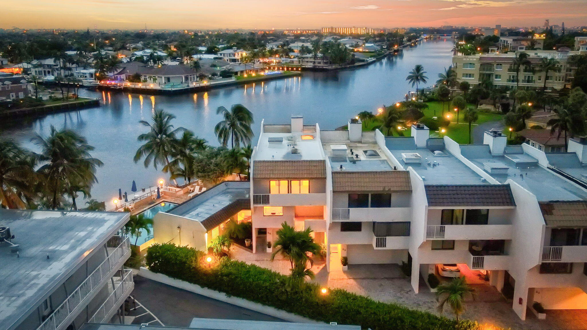 Exquisitely positioned on the coveted Hillsboro Mile, this fully furnished reimagined, coastal residence blends modern sophistication with effortless luxury. Boasting sweeping 180 Intracoastal views from an enviable corner lot, this designer townhome offers nearly 3,000 square feet of impeccably curated living space. Elegant architectural features include a bespoke glass-and-wood staircase, chef's-caliber designer kitchen, custom wine room, indulgent multi-person sauna, ambient electric fireplaces, and a rooftop skylight that invites natural light throughout. Every system is newly upgraded--impact-rated windows, dual-zone A/C, tankless water heaters, Private Elevator & a brand-new roof. Enjoy exceptional amenities including a waterfront pool, Community Dock, & deeded Beach Access.