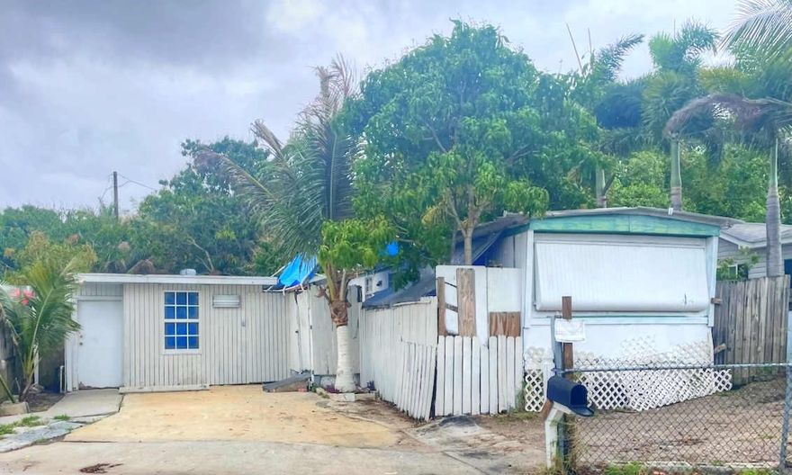 You own the lot...No HOA! Great location close to shopping centers, restaurants, I-95 and more! Make it your own with TLC, Property also has additional 560 sq. ft. cement building which could be customized to your needs. Property has RH zoning which is high density multi family. Loads of potential for investment property.