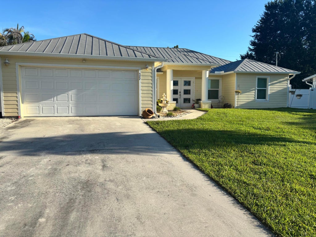Photo of 527 NW Avon Avenue, Port Saint Lucie, FL 34983 (MLS # B26079148)