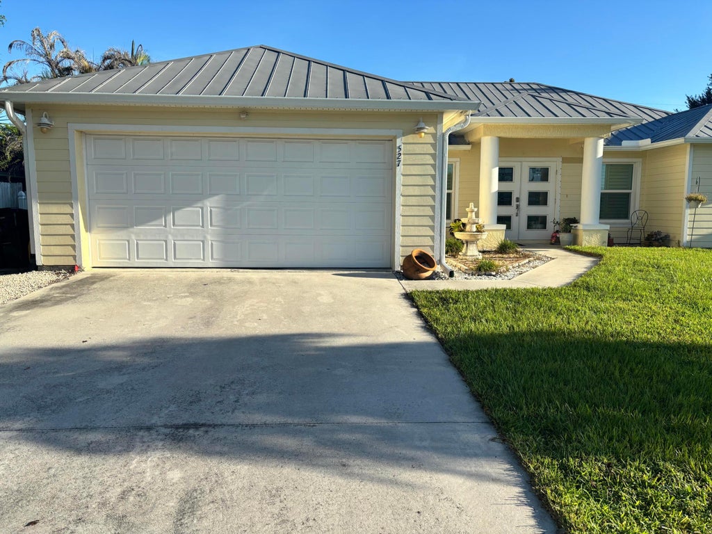 Photo of 527 NW Avon Avenue, Port Saint Lucie, FL 34983 (MLS # B26079148)