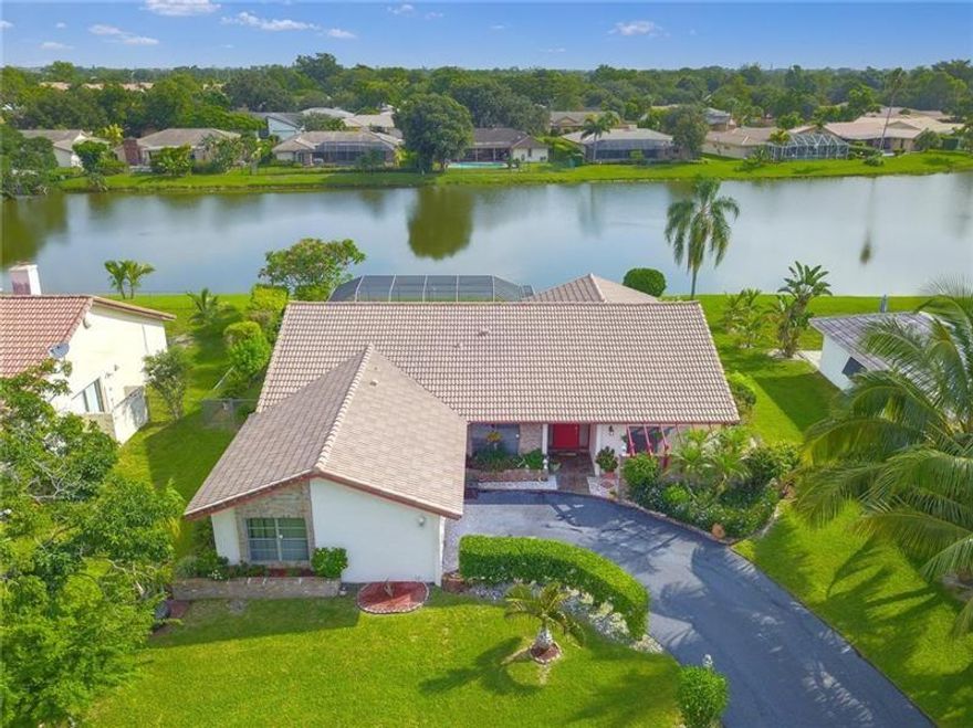 Beautifully kept & updated split-floor home in oversized lot with amazing lake views! Bright and spacious 4 bedrooms & 2 baths home.  Recently installed impact glass.  Spacious gourmet kitchen with stainless steel appliances; remodeled master bathroom; high efficiency washer & dryer;  2-car garage with new impact door.  Expansive driveway with plenty of parking; Large patio & screened-in heated free form pool.  The screen enclosure has been recently replaced.  New, high quality pool vacuum conveys. Best panoramic lake views in the community. House outside freshly painted.  New floors in bedrooms 3 and 4.   Located in Shadow Wood - A NO HOA community.  Close to schools, shopping, restaurants and all major roadways.  A must see home!