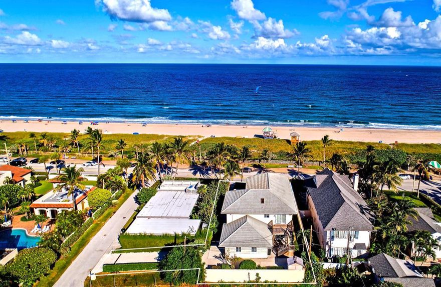 Offering the luxury of beachside living on Ocean Boulevard, directly across from the sands of Delray's world-class beach, this rare estate home commands unobstructed ocean views from one of the highest elevations on Delray Beach's barrier island, where the panoramic perspective focuses on the blue waters sparkling in the sunlight as the coconut palm trees sway in the balmy breeze.  Well-manicured grounds surround the five-bedroom residence, a modern interpretation of traditional design, gazing over the ocean from its perfect position atop a natural ridge, perched some 16 feet above sea level.