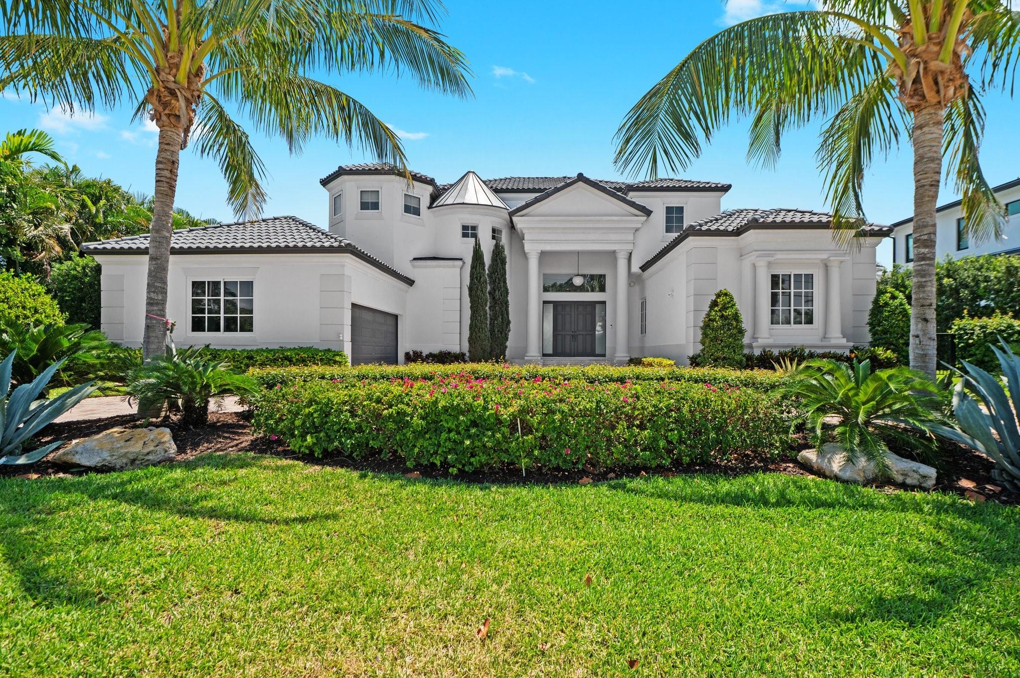 Experience luxury waterfront living in this sprawling 6-bedroom, 5-bathroom estate with over 5,100 sq ft under
air. The home features a wraparound driveway, air-conditioned 2-car garage and 3 bedrooms on the main floor.
Enjoy formal living and dining spaces alongside an open-concept kitchen, breakfast area and family room—all
overlooking 100 feet of stunning water frontage. A wine room fit for the gods awaits, while upstairs you’ll find 3
additional bedrooms, including a grand primary suite with a wraparound balcony. Step outside to a breathtaking
infinity pool and spa, outdoor grill, lush garden, boat dock, lift and ocean access just minutes away.