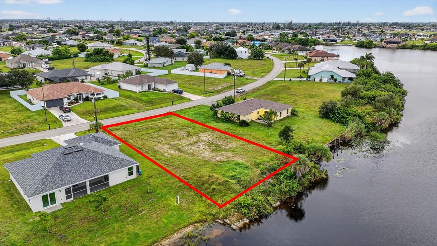 Waterfront living at an incredible price! This 10,280 sq. ft. (.24 acre) lot offers stunning Carousel Lake views and sits on a wide canal in one of Cape Coral's most desirable up-and-coming areas. Imagine building your dream home with peaceful water views, gorgeous sunsets, and quick access to the popular Coral Oaks Golf Club—just minutes away.

With no HOA, you'll enjoy the freedom to design the home you truly want. The property will need well and septic, and there's currently no seawall, but neighboring new builds have been graded directly to the canal. If you choose to add one, seawalls typically range from $20K-$25K.

At $56,500, this lot is priced well below comparable properties—canal lots across the water are listed at $59K-$60K, and Carousel Lake lots run between $105K-$110K.