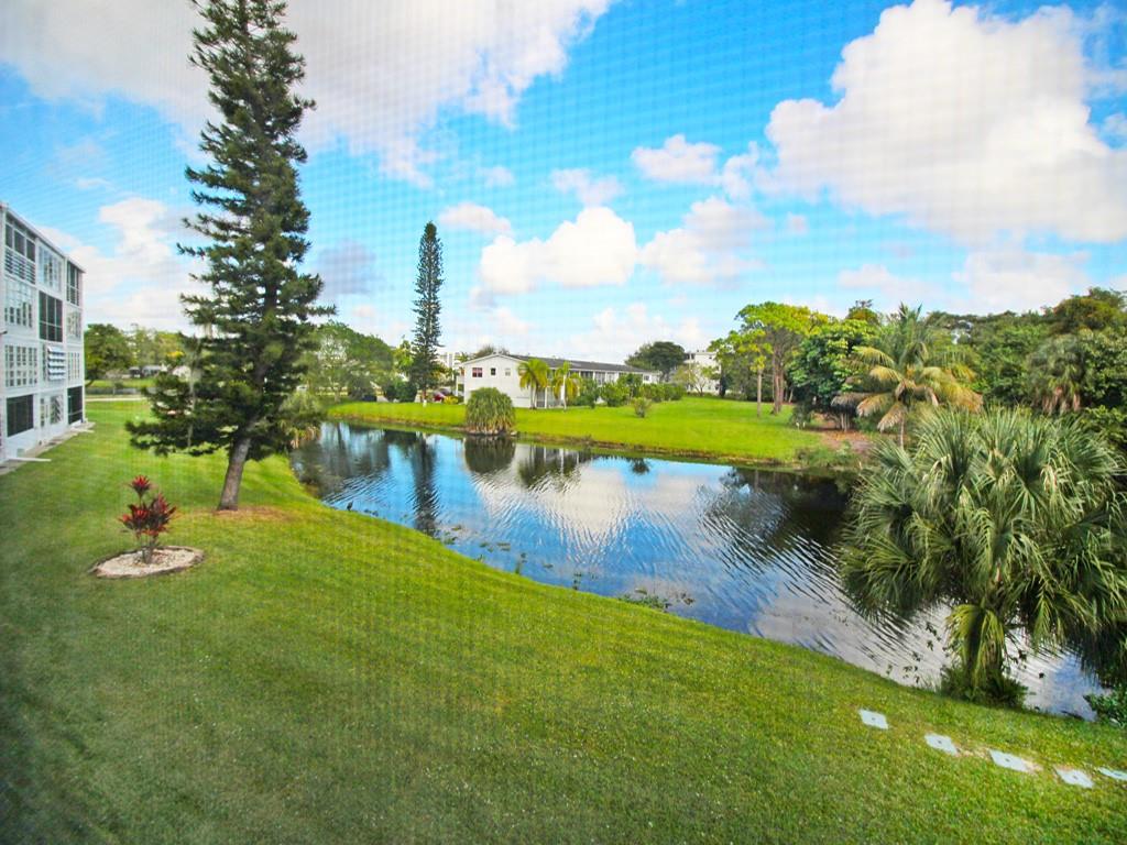 Lovely CANAL VIEW from this renovated 1 bedroom w/2 FULL BATHS on the TOP FLR. Located in the lovely active adult comm of Century Village Deerfield Beach, this condo comes furnished w/upgrades including a beautifully renovated kitchen featuring granite cntrs, tile backsplash, white shaker cabs, ss appl & recessed ltg, tile in open areas & lam in bedrm, replaced electrical panel & HWH, A/C 2018, remodeled bathrms w/ shower stall & glass shower doors in primary. The encl patio has sliding plexi glass windows overlooking a serene view of the canal & water fountain! Bldg. has a NEW ROOF & a BBQ/picnic area for entertaining guests! Enjoy the resort style amenities.. gated, 24 hr sec, free transportation, pools, tennis, pickleball, cafe, gym, theater, classes, clubs & more! Assoc. Claims 55+