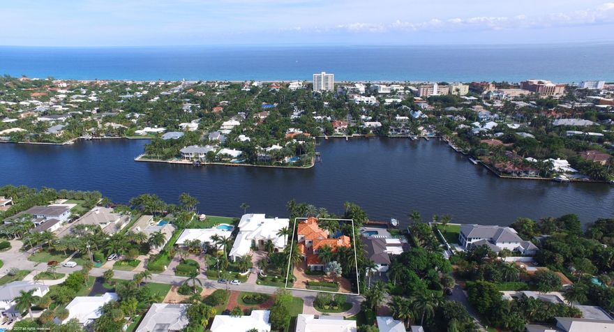 Enjoy expansive intracoastal views from this estate home perfectly situated on an over-sized lot. The custom interior features four separate guest suites Classically styled interiors include a gracious foyer, a stunning waterfront living room, dining room, and a generous club room offering a full-service bar and wine cellar.  Adjacent is a game room/library.   The chef's kitchen opens to a light-filled family room and breakfast room.  All open through French doors to the loggia with cypress ceilings, a summer kitchen and fireplace providing outdoor living spaces and capitalizing on the gorgeous views. A private in-law suite is located off the loggia. Two blocks from shops, galleries and restaurants of Atlantic Avenue, yet all the privacy of a secluded estate.  See exclusions.