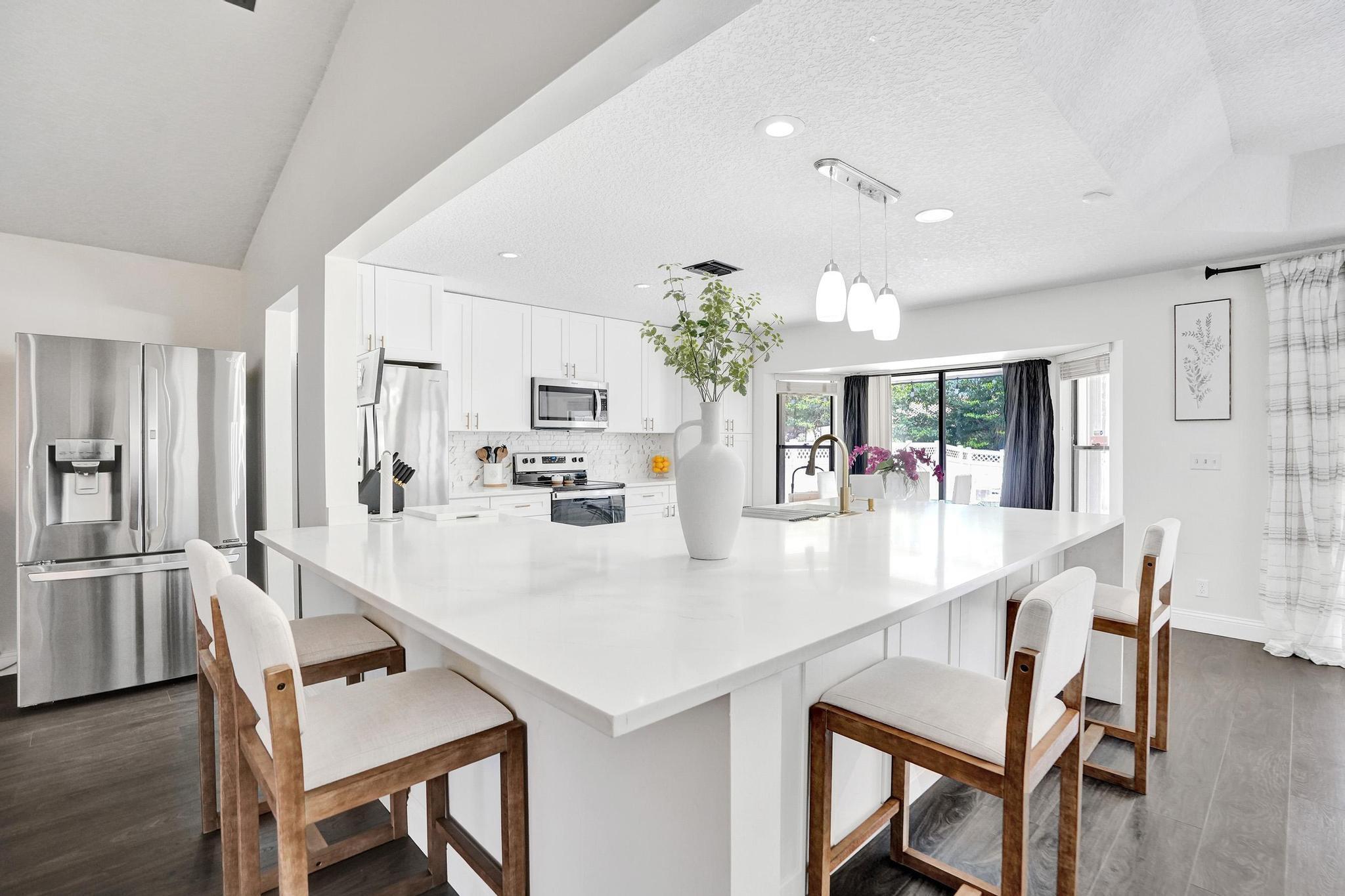 Beautifully renovated 4-bedroom, 2-bathroom home with 2-car garage in the highly desirable Crossings community of Coral Springs. This move-in ready home features a spacious, open layout with vaulted ceilings, large living and dining areas, and a fully remodeled kitchen (2023) with modern cabinetry, plenty of counterspace and stainless-steel appliances. Laminate flooring throughout (2019) except the bathrooms. The oversized master suite includes a generously sized walk-in closet and direct access to the pool area. One of the bathrooms also serves as a cabana bath, offering convenience for outdoor entertaining. Enjoy your private, fenced backyard oasis, refinished pool and spa (2019). Additional updates include accordion shutters, Newer A/C (Aug 2024), and water heater (2019).