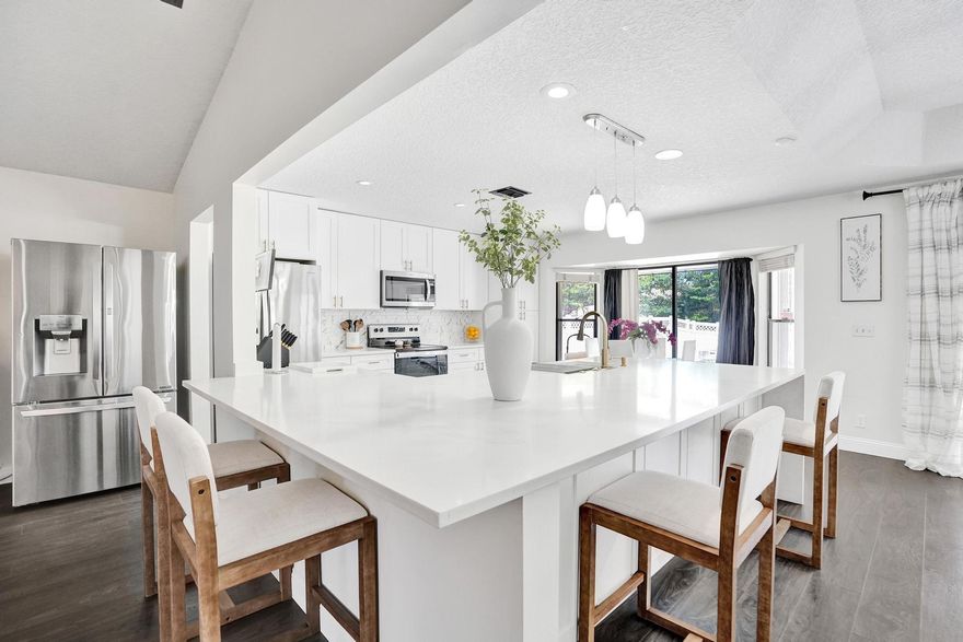 Beautifully renovated 4-bedroom, 2-bathroom home with 2-car garage in the highly desirable Crossings community of Coral Springs. This move-in ready home features a spacious, open layout with vaulted ceilings, large living and dining areas, and a fully remodeled kitchen (2023) with modern cabinetry, plenty of counterspace and stainless-steel appliances. Laminate flooring throughout (2019) except the bathrooms. The oversized master suite includes a generously sized walk-in closet and direct access to the pool area. One of the bathrooms also serves as a cabana bath, offering convenience for outdoor entertaining. Enjoy your private, fenced backyard oasis, refinished pool and spa (2019).  Additional updates include accordion shutters, Newer A/C (Aug 2024), and water heater (2019). Abundant natural light, and a great flow for indoor-outdoor living. Located near shopping, parks, and dining. A true gem.. schedule your showing today!