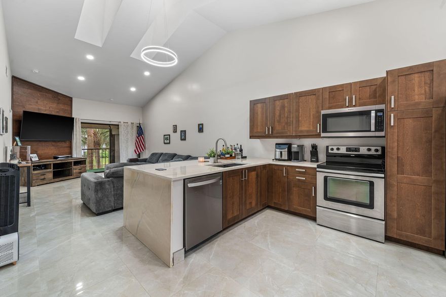 :QUALIFIES FOR PALM BEACH COUNTY'S SMART GRANT PROGRAM FOR $15,000 FOR LENDER CREDIT TO THE BUYER through a county's approved lender....Experience modern lakefront living in this fully renovated 2-bed, 2-bath condo with bright open open, vaulted ceilings, smart lighting, skylights, tile throughout, and a sleek open kitchen. Enjoy built in closets in master suite, an in-unit washer/dryer, tank-less water heater, and an attached one-car garage. A spacious balcony offers tranquil lake views, perfect for relaxation. Located in the gated River Bridge community with on-duty guard, resort-style pools, jacuzzis, tennis, basketball, bocce, playgrounds, and a clubhouse. Close to top schools, shopping, dining,beaches, and major highways in Greenacres