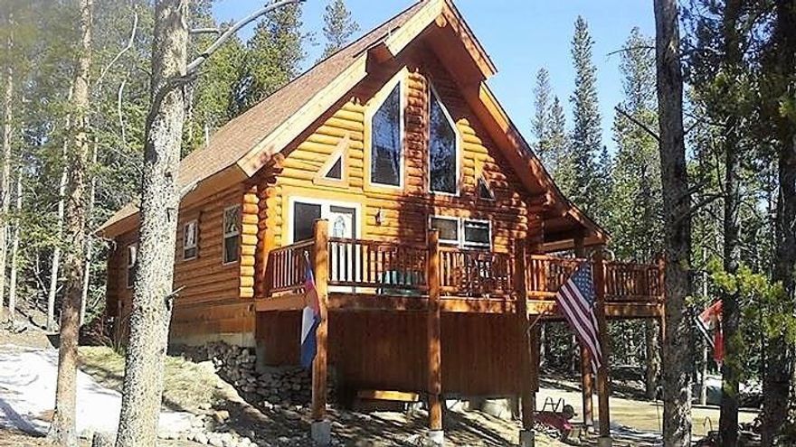 FURNISHED log home in wooded area. Open floor plan. Walk-out bsmt. Att.1 car wide garage. EVERYTHING in pictures stay. Wrap around deck front (uncovered), side (covered). Tall picture windows w/great view. Shed has log splitter, chain saws, snow blower. 3 full baths. All appliances stay. Move in ready! Perfect as 2nd home or great starter on road maintained all year round. Driveway graveled. Deck furniture/grill stay. Watch moose, elk, wildlife stroll thru this 1+ acre lot.