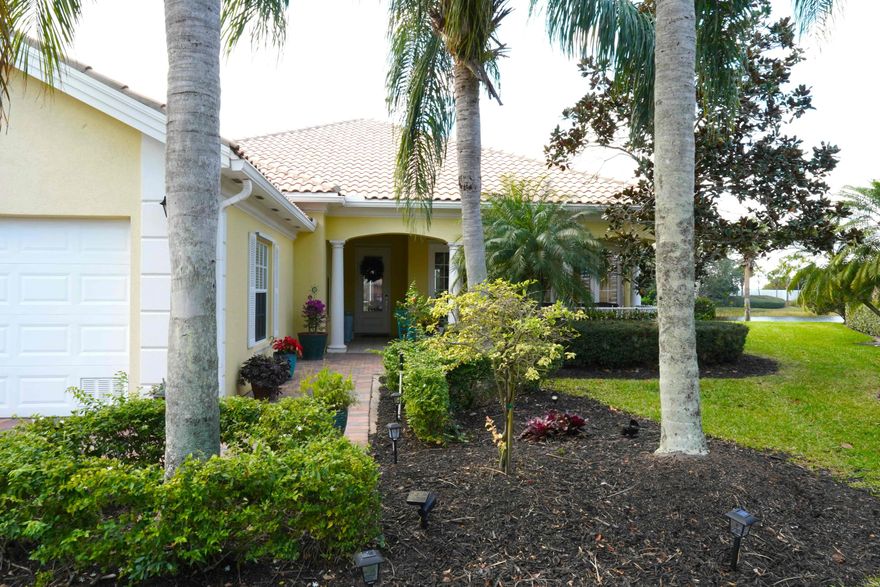 Experience unparalleled privacy and luxury in this exquisite lakefront Audubon sanctuary retreat. Situated at the end of a quiet cul-de-sac in Lakes of Tradition with no through traffic, this 4 bedroom, 4 full bathroom Carlyle Model quality built DiVosta home offers long, south-western-northern-exposure water views and ultimate seclusion with no neighbors directly behind. The interior ''shows like a model,'' boasting sophisticated pecan-shaved flooring in the main living areas and elegant gray-porcelain wood-look tile for easy maintenance. The gourmet kitchen is a chef's dream, featuring LG stainless steel appliances, tumbled marble backsplash, and a custom lighting package including lighted cabinets, recessed ''high-hats,'' and designer chandeliers.  Architectural details abound with crown molding throughout and a massive master suite featuring his-and-her vanities, a soaking tub, and multiple walk-in closets. Enjoy the Florida lifestyle on the expansive screened patio, finished with premium gray pavers, paddle fans, and a Miami-approved "Storm Smart" motorized shade perfect for both storm protection and instant privacy. Backyard offers plenty of space for a pool. Additional upgrades include a new 2025 HVAC system, a central vacuum system, a new 2024 electric water heater, a dedicated laundry room with quartz countertops, and an oversized two-car garage with a new opener and attic storage. From the charming private front courtyard to the lush tropical landscaping and professional outdoor lighting, every inch of this home has been meticulously appointed. A true must-see! Live in the heart of Tradition! Located in The Lakes at Tradition, this home sits inside one of Port St. Lucie's most sought-after master-planned communities known for its walkable Town Center, year-round events, and an active outdoor lifestyle. Residents enjoy a true neighborhood feel with sidewalks, trails, and easy access to parks and everyday conveniences. The Lakes at Tradition offers resort-style living with a newly refurbished clubhouse that includes two heated pools, a fitness center, tennis, basketball, and pickleball, plus social spaces and community activities all within a gated setting. Whether you're looking for an active lifestyle or a relaxed Florida pace with everything close by, Tradition delivers the best of both.