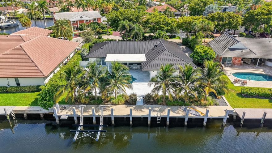 Located in Fort Lauderdale's premier 24/7 armed security guard-gated deepwater community. Move-in ready & furnished for quick closing. Custom island-inspired single level residence. 2022 total renovation shows as NEW: metal roof, plumbing to street, all new electrical, air conditioners, tankless water heater & generator. Latest open concept living, great room, Chef's kitchen, porcelain tile floors, new impact glass & interior doors. Private Primary Suite, dual closets, new modern spa style bath, enclosed water closet, soaking tub & floating vanities. Split floorplan: 2 secondary bedroom suites, office (4th bed), cabana bath, air-conditioned garage. Most rooms access pool & wide-open radius turning basin views, 95ft protected dockage. Perfectly located for Pine Crest & other A rated schools
