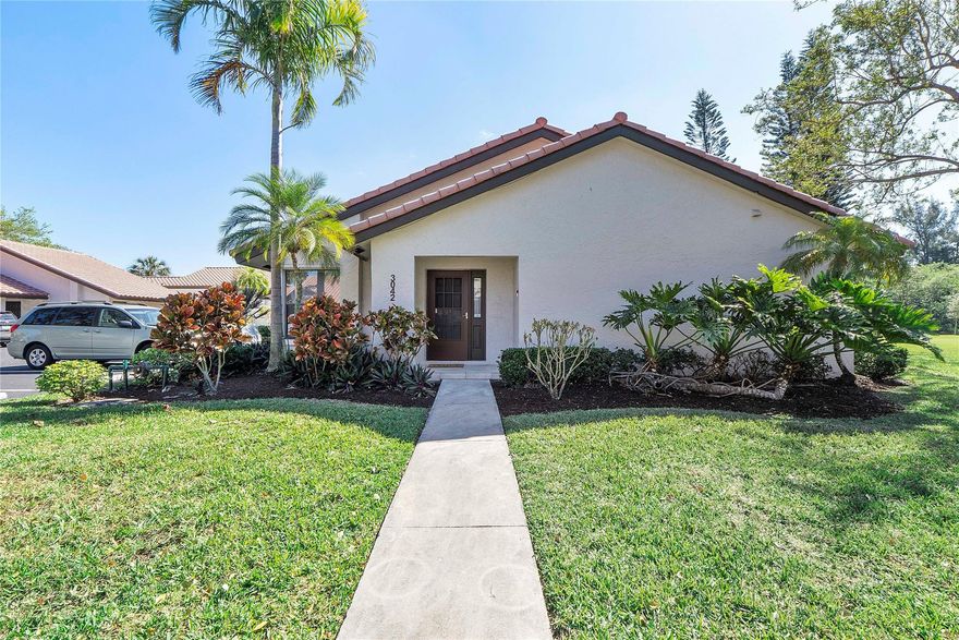 Welcome to effortless Florida living in this UPDATED, MOVE-IN READY corner villa designed for comfort & privacy. A PRIVATE entrance opens to a bright 2BR/2BA split floor plan w/vaulted ceilings & natural light throughout. The designer kitchen features white shaker cabinetry, quartz countertops & SS appliances, while the fully renovated primary bath offers a sleek walk-in tiled shower & elegant vanity. Four sliding doors lead to an oversized covered, screened patio — your own retreat w/ STUNNING lake, golf course & nature VIEWS. Enjoy a 2025 A/C, full-size washer/dryer, excellent storage & 2 parking spaces right by the front door. Lovely community heated pool & spa. Deer Creek has NO mandatory golf membership. CENTRAL LOCATION, minutes to Deerfield Beach, shopping, parks, & major highways.