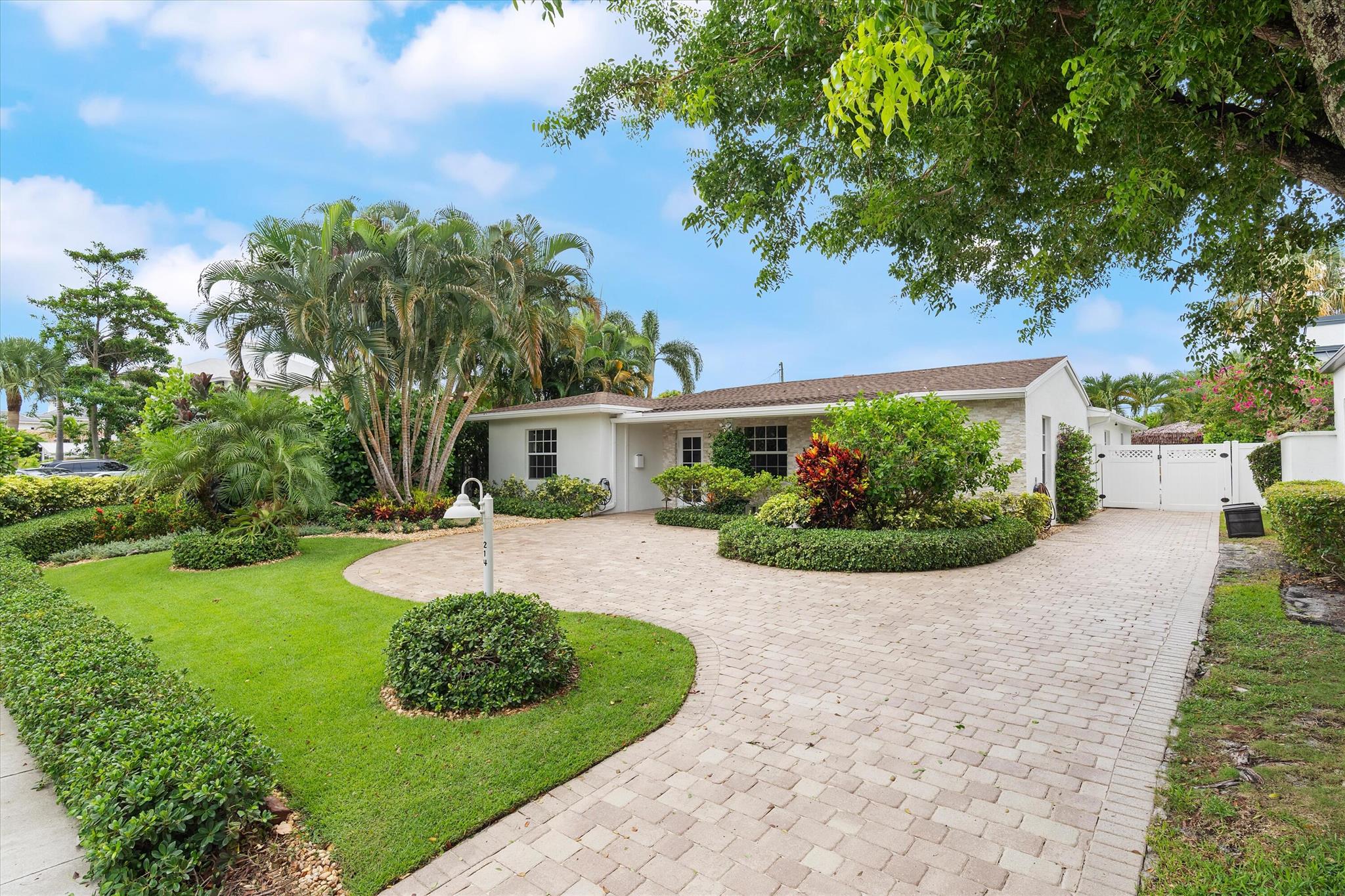 Newly renovated Summer of 2024, professionally orchestrated turn-key single-story CBS constructed home on elevated 10,000+SF lot, impact glass throughout in sought after location of Alhambra Park. 214 Alhambra Place is ideally located between S. Olive Avenue and Washington Road, a short walk to Intracoastal Waterway and Summa Beach Park and Trail. This home offers a well-thought-out floor plan that can be utilized by family, empty nesters or someone who loves to entertain. Main house offers 4 bedrooms, 3 baths and home office. You will be astonished by the clever use of space in the rear of the property. Covered patio space, redone pool, outdoor shower, entirely renovated guest house with full bath and kitchen, tiki bar, extra living space that can be home gym or artist studio.