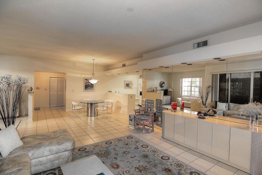 WELL MAINTAINED GROUND FLOOR CONDO WITH WIDE OPEN FLOORPLAN. 2 BEDROOMS + DEN, 2 FULL BATHS AND 1 CAR GARAGE.  LARGE L-SHAPED PATIO OVERLOOKING GOLF COURSE AND LAKE WITH FOUNTAIN.  CAN BE PURCHASED FURNISHED. MANDATORY MEMBERSHIP REQUIRED.