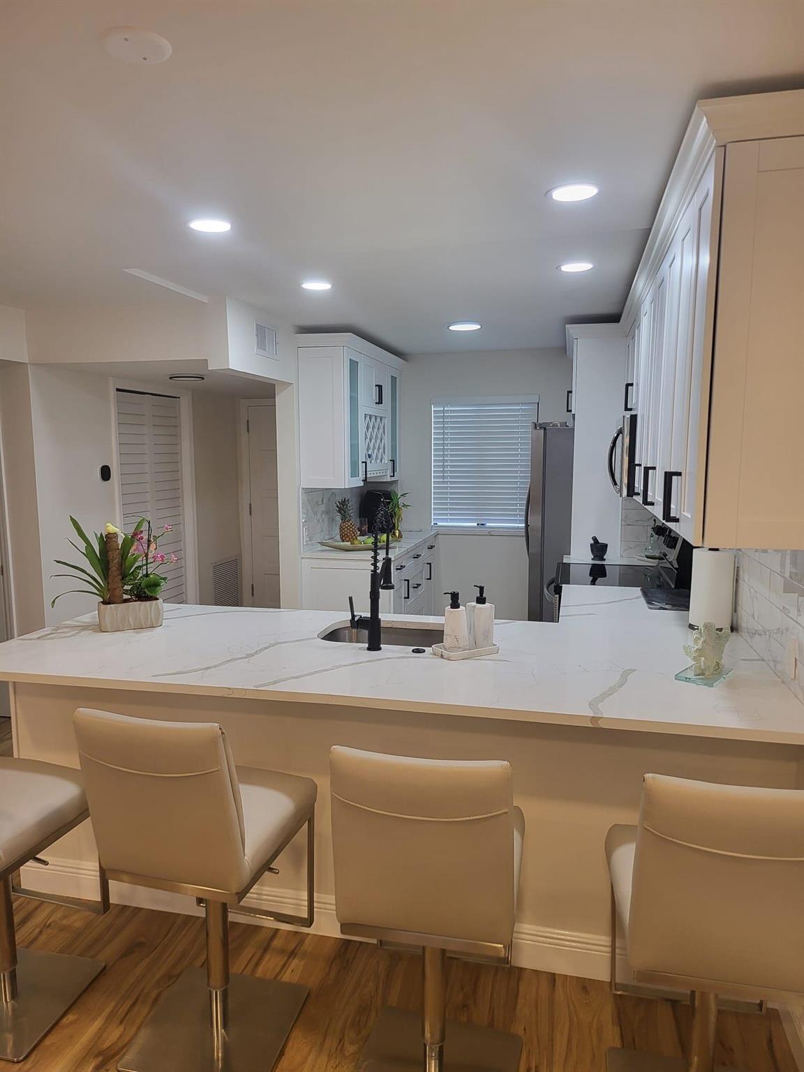 :Owner will PAY 2 month HOA fee at closing. THIS BRIGHT and STUNNING 2 Bed/ 2 Bath, completely renovated, Expanded open kitchen with custom wood cabinetries; Quartz Marble Countertop, Stainless Steel appliances. Updated General Electric Panel. All new custom light fixtures. Laminate Wood Floors throughout waterproof, Scratch & Stain Resistant. All new modern baseboards, paint, and smooth ceilings throughout. Two Walk-in closets. Screen enclosed patio/Florida with new ceramic tile. Monthly fee includes Digital Cable, Wi-Fi, Water, Exterior Insurance & Maintenance, Pool Service, Elevator Service, Manned Gate and Security Patrol. After one year, you can rent seasonal minimum 90 days, 4 times a year. Unit is Centrally located, Close to Turnpike, Wellington, PBI Airport and much more.