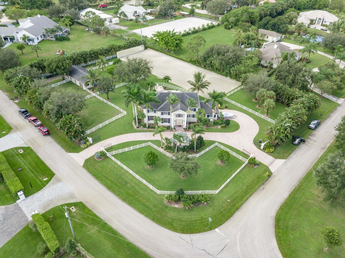 Contemporary renovation just completed on this well located private estate on almost 2 acres . Just a short golf cart ride to all 3 of the major local equestrian venues. The property includes a 4,200 sq home with open concept design with 7 bed, 5 bath and a living room to match! Two master bedroom suites on each level of house consist of a large bedroom , two walk-in closets, and a glamorous large master bathroom with soaking tub, dual vanities, large frameless glass walk-in shower. Elegant design from entering the house and walking to the second floor on a staircase with glass railings. Expensive flat European ceilings on the first floor and Italian chandeliers give a stylish look to the house. Marble wall and matching kitchen tables give the house spectacular design.