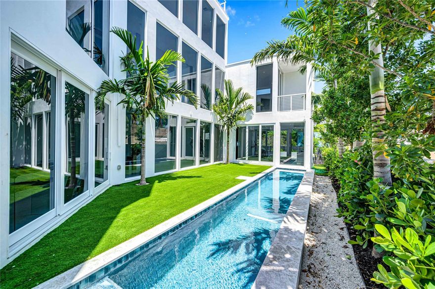 Live in a brand-new ocean-facing home in the serene Lauderdale Beach neighborhood, east of A1A. This striking glass-walled house on a palm-lined boulevard overlooks a beachside park and the Atlantic. The entry level features a spacious family room that opens to a covered patio and two saltwater pools, including a 38-foot long pool. Guests will appreciate the guest suite, wet bar, and powder room on this level. The main floor has high ceilings, floor-to-ceiling windows, and a great room with a DACOR gas kitchen and two more guest suites. The third-floor primary suite includes three closets and a large balcony with expansive views. An elevator or stairs leads to the roof deck, ideal for sunbathing or stargazing. Available immediately.