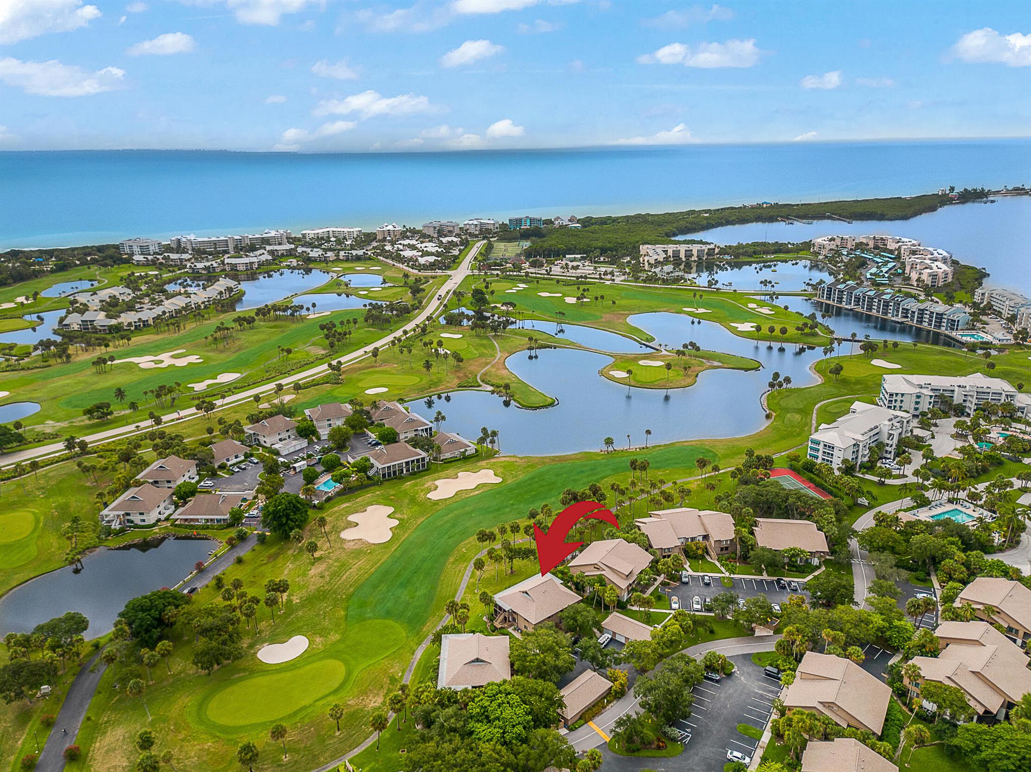 Prime location with beautiful views of the golf course and lake, just a short stroll to the beach! This bright and airy first-floor end unit, fully redone last year, offers two spacious bedrooms and two full baths. The updated white kitchen features Quartzite countertops, stainless steel appliances, and a breakfast bar, opening to a light-filled living area. New vinyl flooring and fresh interior paint give a modern touch. The master bedroom opens to a private patio, perfect for relaxation. Enjoy dining indoors or out on the covered, screened patio, perfect for catching the cool breezes. A rare 1-car garage provides extra storage. Amenities include a heated pool, tennis courts, and BBQ area, with optional membership available.