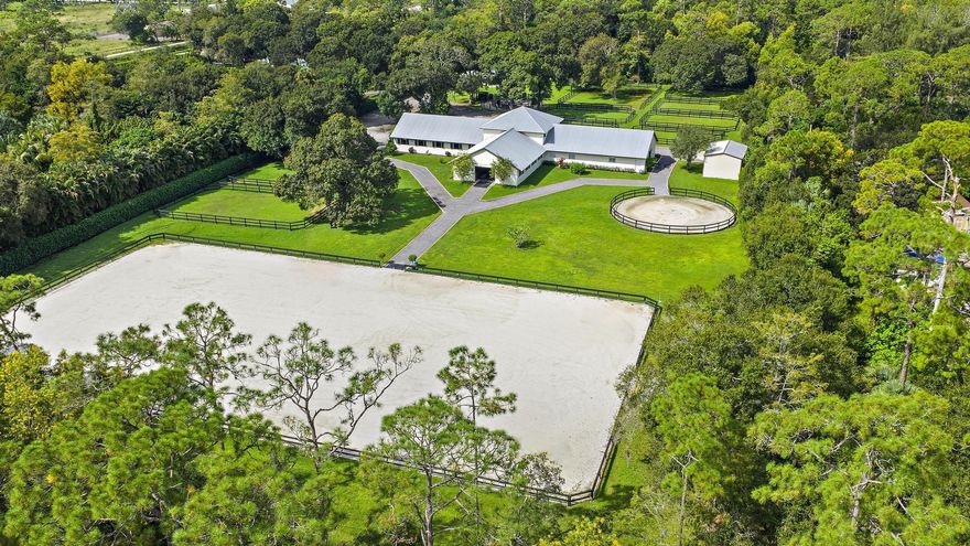 Welcome to Angel Heart Ranch, one of Loxahatchee's closest farms to Wellington, ideally located near WEF, Global Dressage, and International Polo Club. The farm features a 135' x 230' arena with excellent sand footing, exercise ring, and electric horse walker. The 18 stall center-aisle CBS barn includes 6 interior wash stalls, laundry room, 3 tack rooms, storage rooms, and 12x12 matted stalls complete with a fly-spray system. Property-wide security cameras ensure peace of mind, while 9 large paddocks provide ample turnout space. A tractor and drag system are included, along with a storage shed for convenience. Housing accommodations include a recently renovated 3 bedroom, 2 bath guest house and a 3 bedroom, 1 bath barn apartment, offering on-site housing for owners or staff.