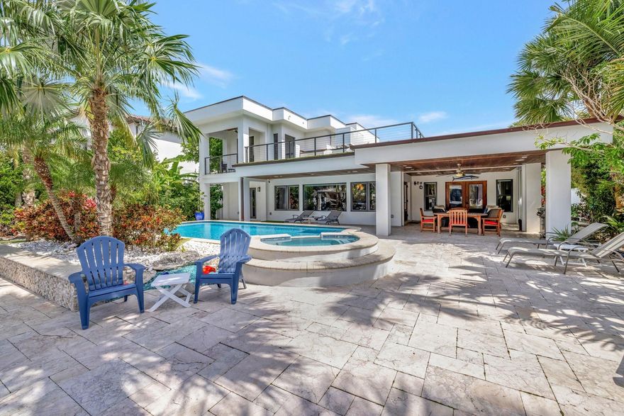 Located in the prestigious, guard-gated Seven Isles with 24/7 security patrol, this fully remodeled (2018) 4BD/4.5BA waterfront home offers 76 feet on a wide canal with a boat lift, ocean access, and no fixed bridges. With 3,766 sq ft of living space, it features two expansive primary suites—one up, one down—ideal for guests or multigenerational living. Enjoy a resort-style pool, spa, lush subtropical landscaping, whole-house generator, and chef’s kitchen. Close to the beach and Las Olas from this prime Fort Lauderdale location. Designed for both elegance and function, the open floor plan is ideal for entertaining, with light-filled living spaces that flow effortlessly to the outdoors. Minutes from world-class shopping, dining, this home is the complete South Florida lifestyle package.