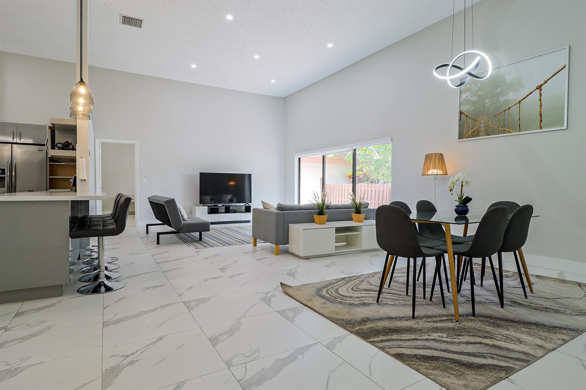 Based in the highly desirable boating community of Harbourwood Villas in Hallandale Beach, this fully renovated 3-bedroom, 2-bath villa blends modern design with coastal lifestyle. Just minutes from the beach, dining, shopping, golf, and Gulfstream Park Casino. It features an open, light-filled layout with sleek ceramic flooring, a stylish new kitchen, updated bathrooms, and all-new appliances. With two parking spaces, a private backyard with a fruit tree, and a charming walkway. The standout feature is a private boat dock and slip for up to a 45-foot vessel in the community marina, offering direct access to the Intracoastal and ocean. Offered fully furnished for turnkey convenience, with water and internet included in the HOA. This is effortless, upscale living by the water.